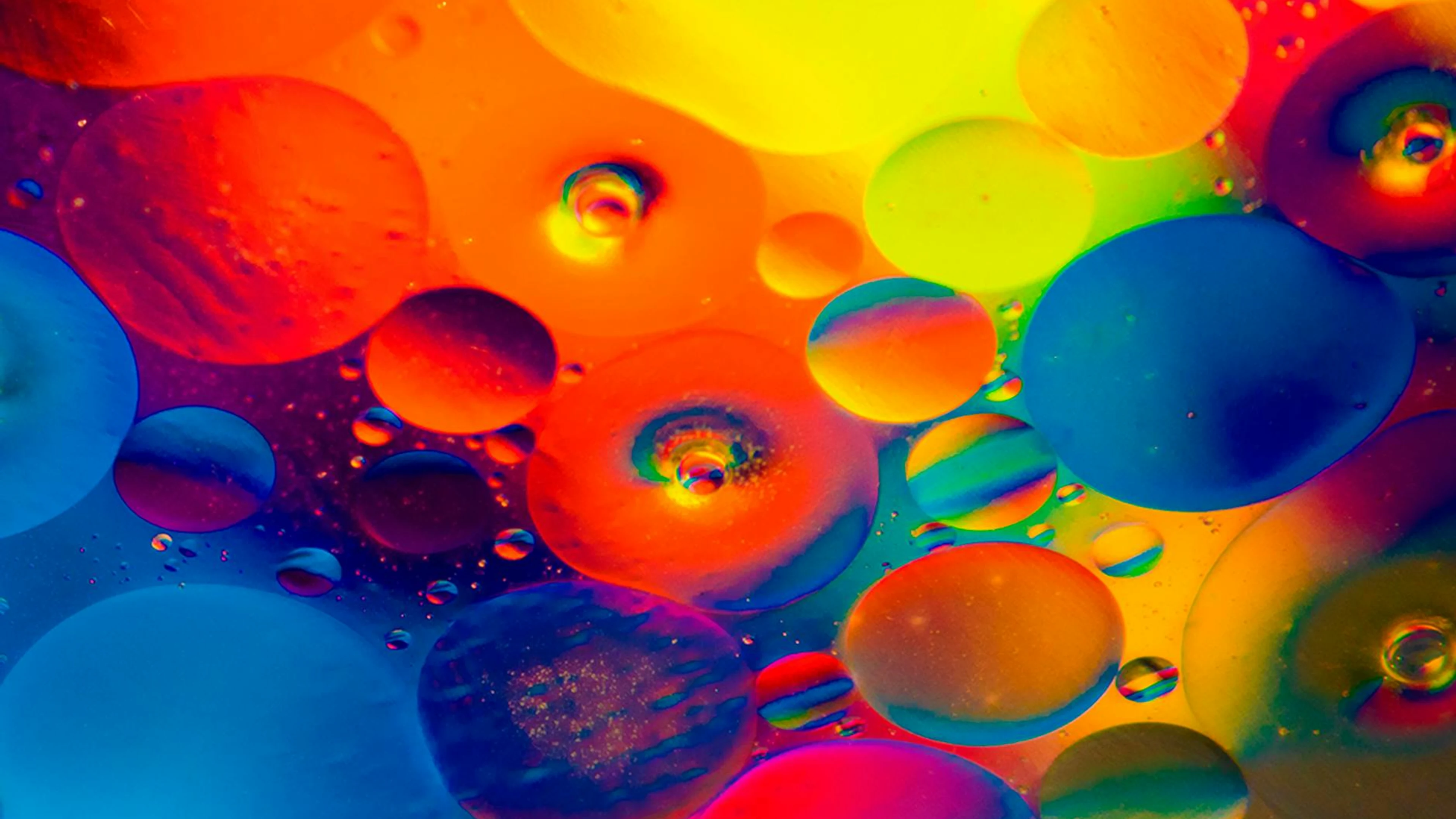 Colorful abstract artwork featuring vibrant bubbles of oil immersed in water, sh - free 4K Ultra HD abstract wallpaper for desktop