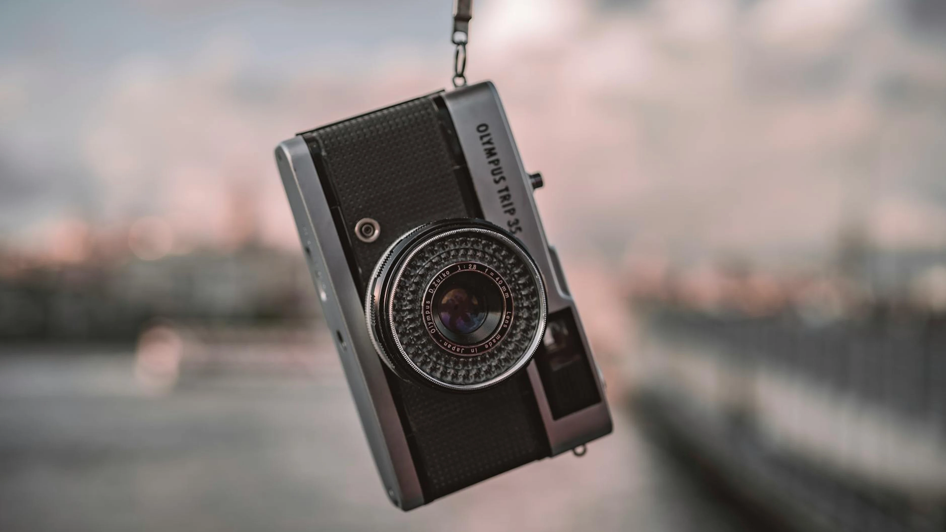 Close-up of a classic Olympus Trip 35 camera with a blurred background, capturin - free 4K Ultra HD aesthetic wallpaper for desktop
