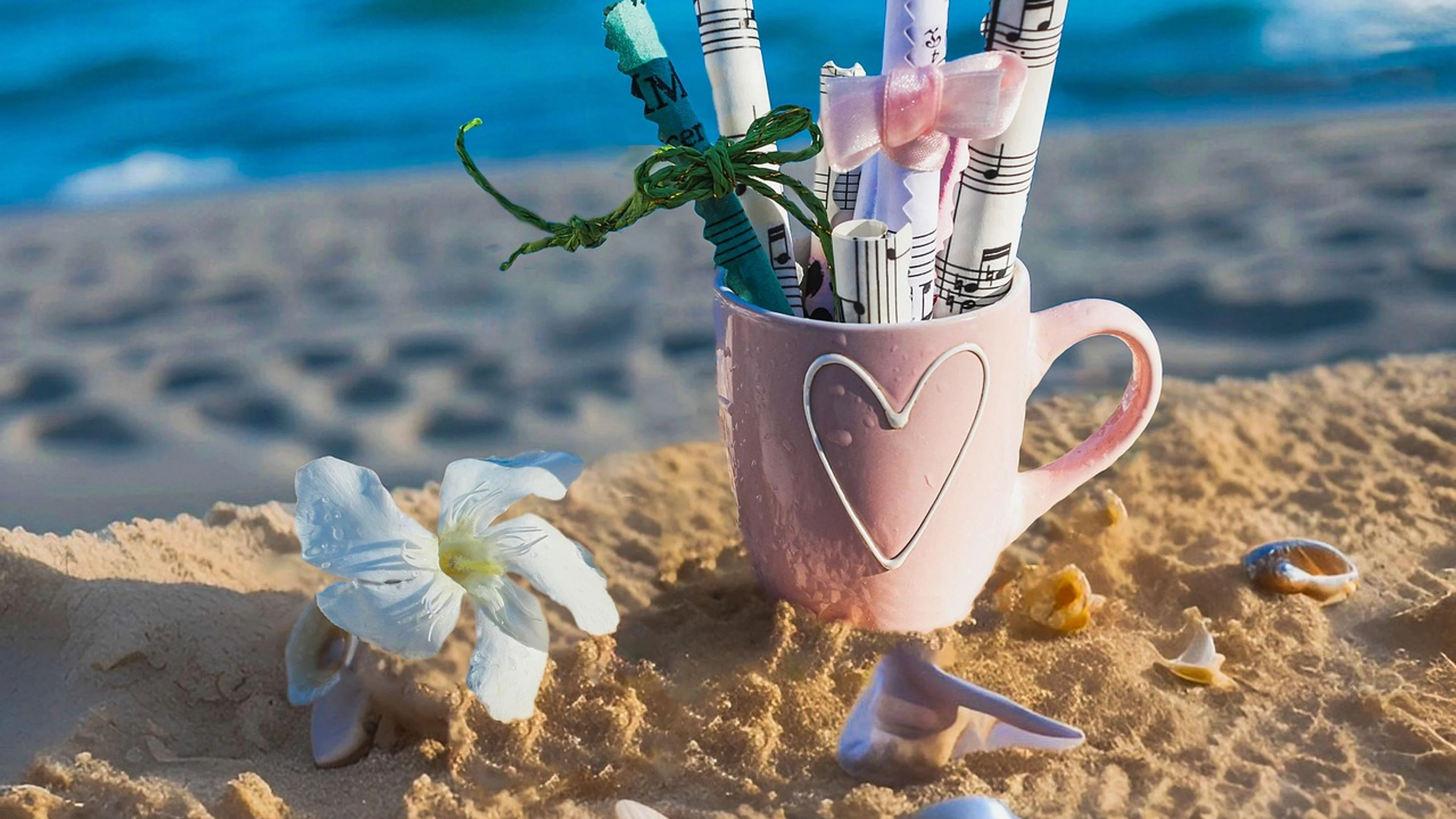 Music notes beach scene rolled sheet music - free 4K Ultra HD aesthetic wallpaper for desktop