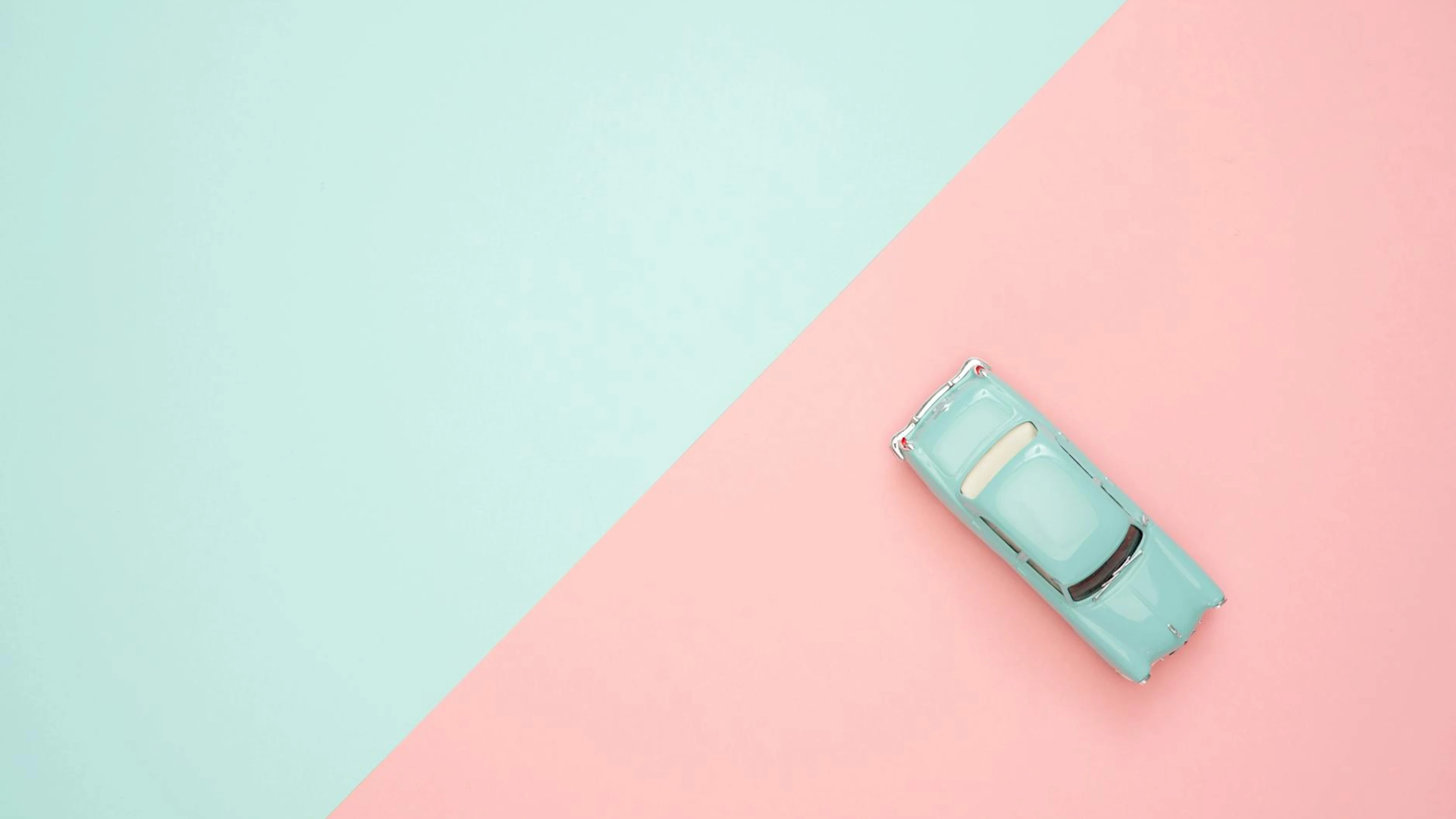 Toy car on a pastel pink and blue background, representing simplicity and retro - free 4K Ultra HD anime wallpaper for desktop