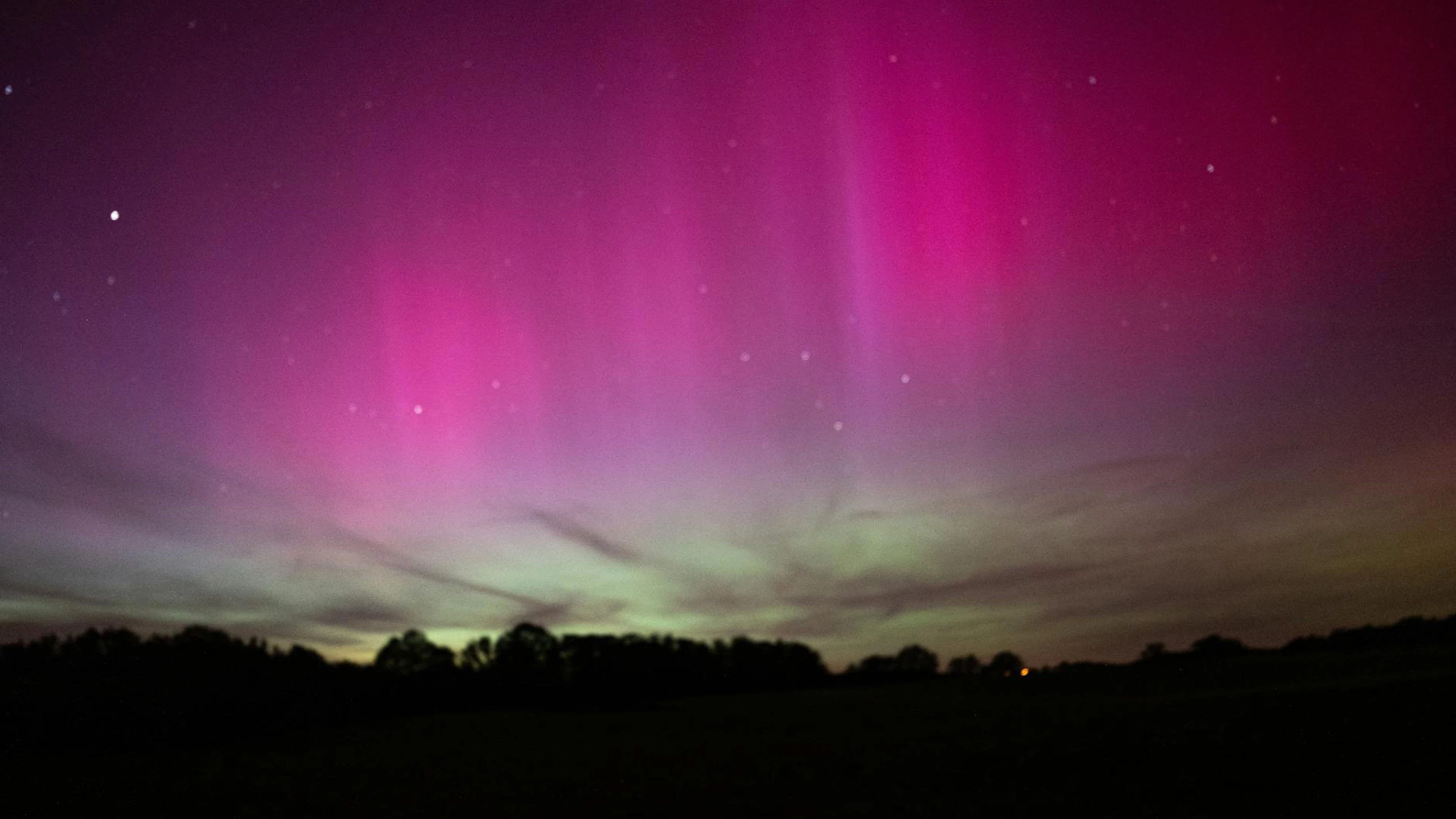 Majestic aurora borealis with vibrant purple hues illuminating the night sky ove - free 4K Ultra HD aurora wallpaper for desktop