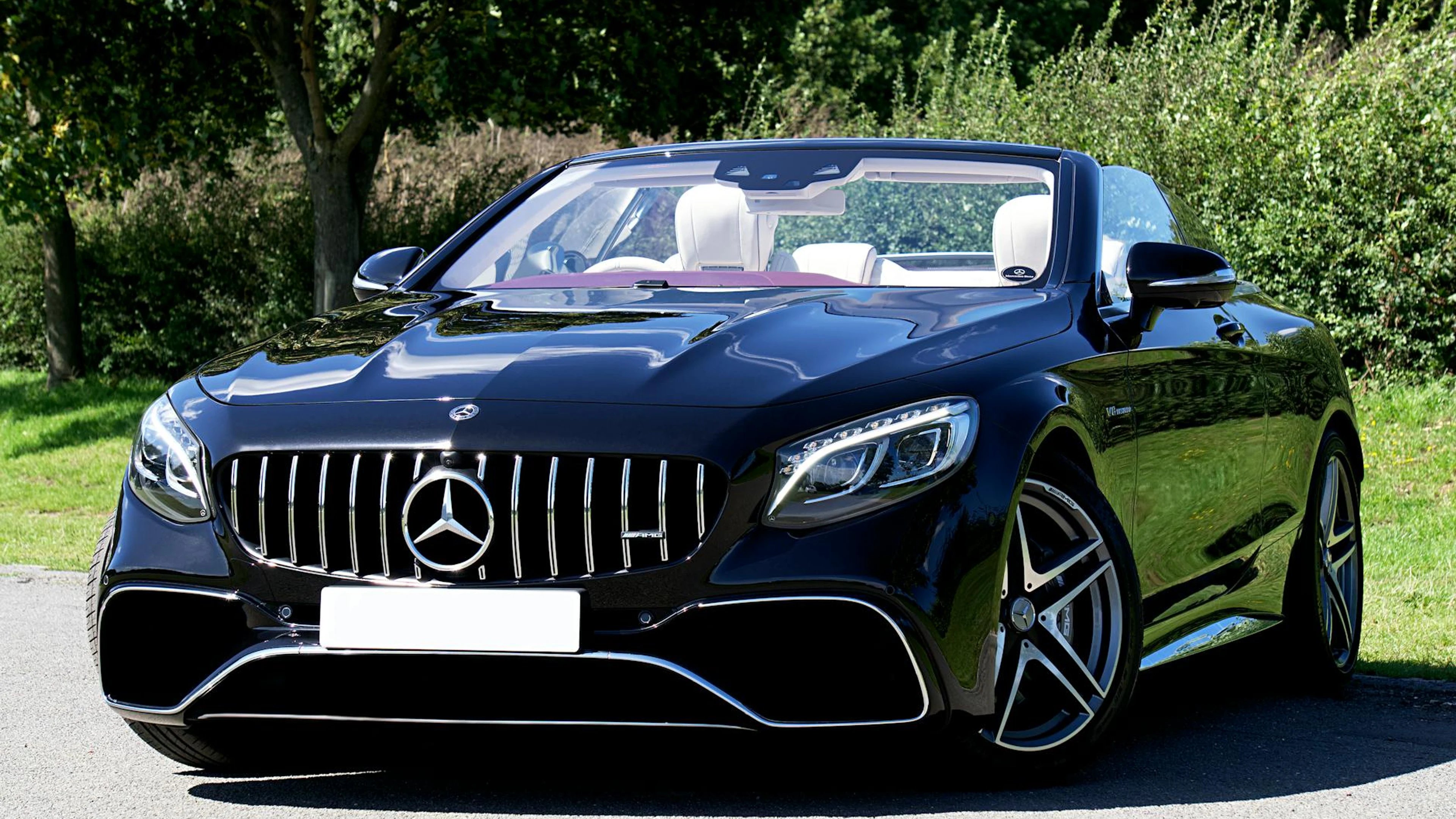 Close-up of a black luxury convertible car parked outdoors on a sunny day. - free 4K Ultra HD cars wallpaper for desktop