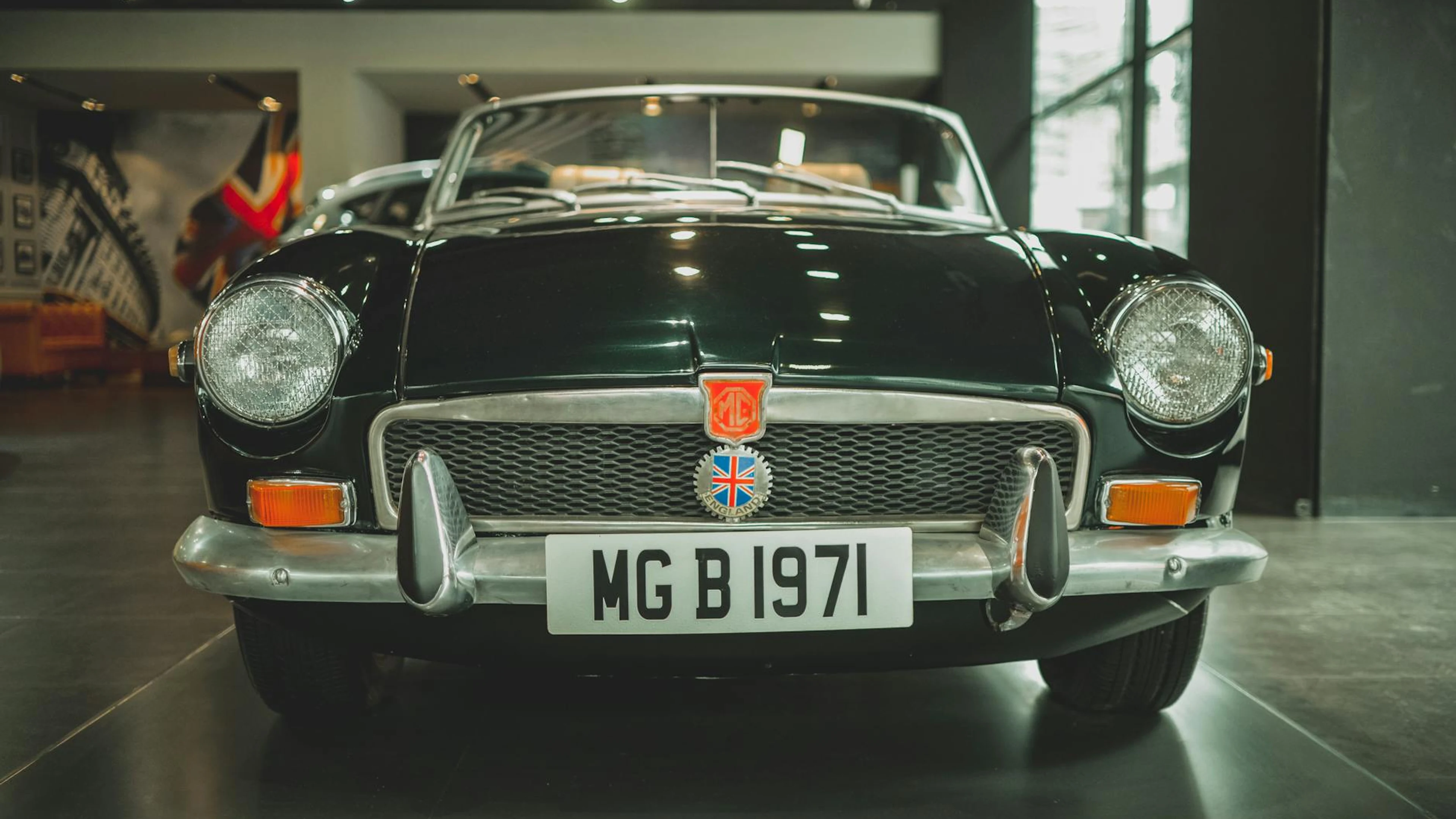 Explore this stunning 1971 MG B classic car displayed in an elegant indoor showr - free 4K Ultra HD cars wallpaper for desktop
