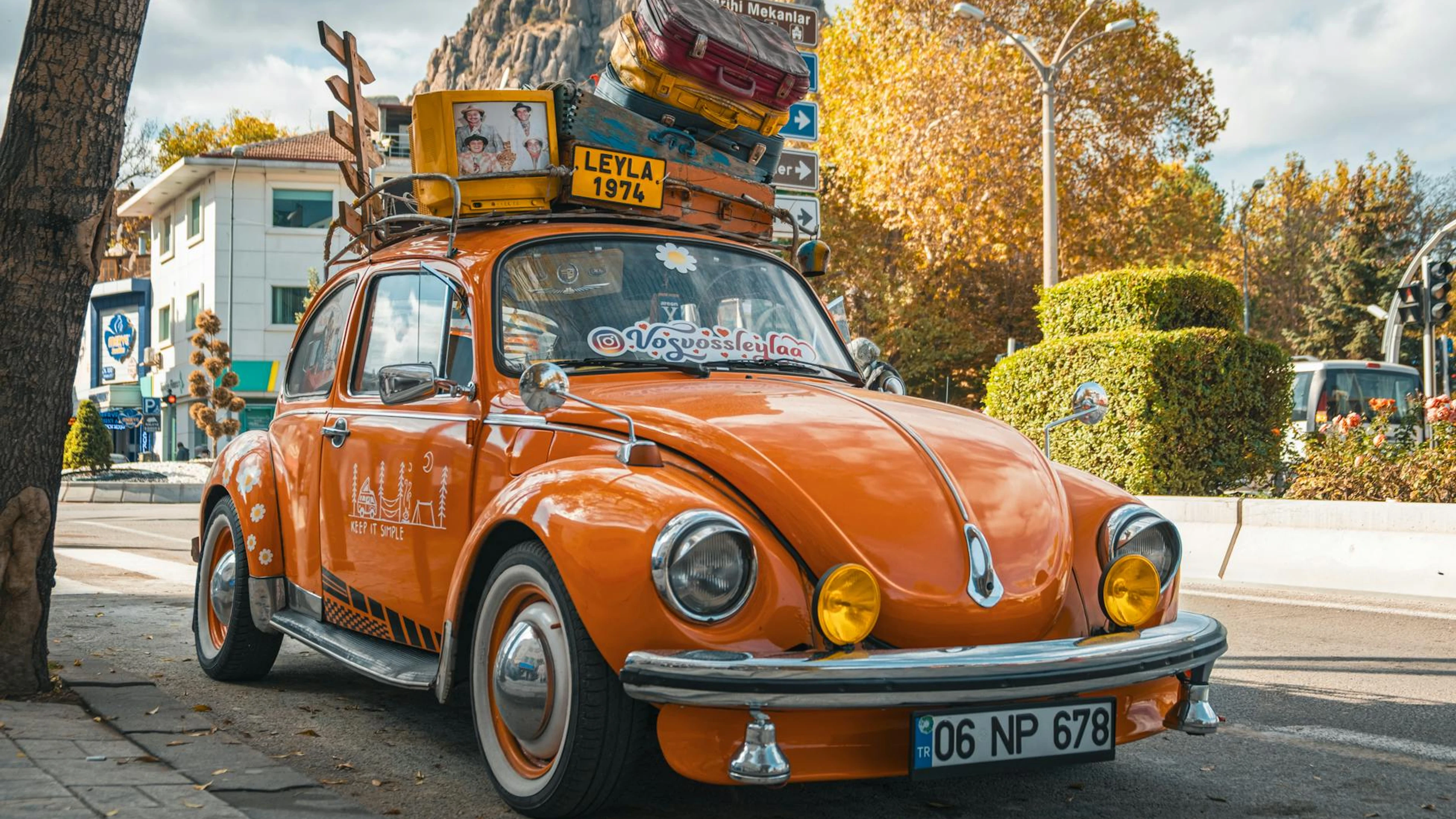Orange Volkswagen Beetle parked on a vibrant street in Afyonkarahisar, Türkiye, - free 4K Ultra HD cars wallpaper for desktop