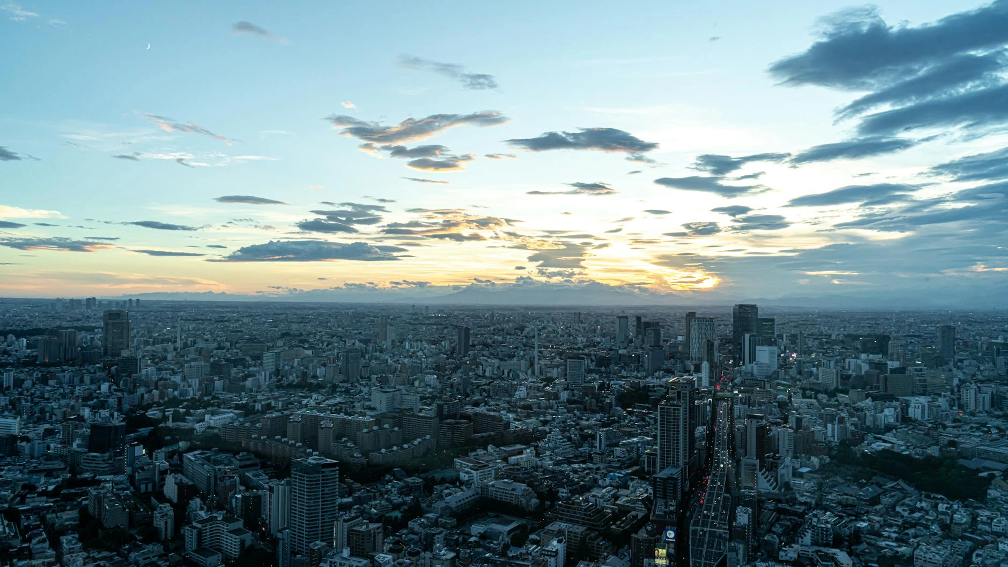A breathtaking aerial view of Tokyo cityscape during sunset with a vivid sky. - free 4K Ultra HD city wallpaper for desktop