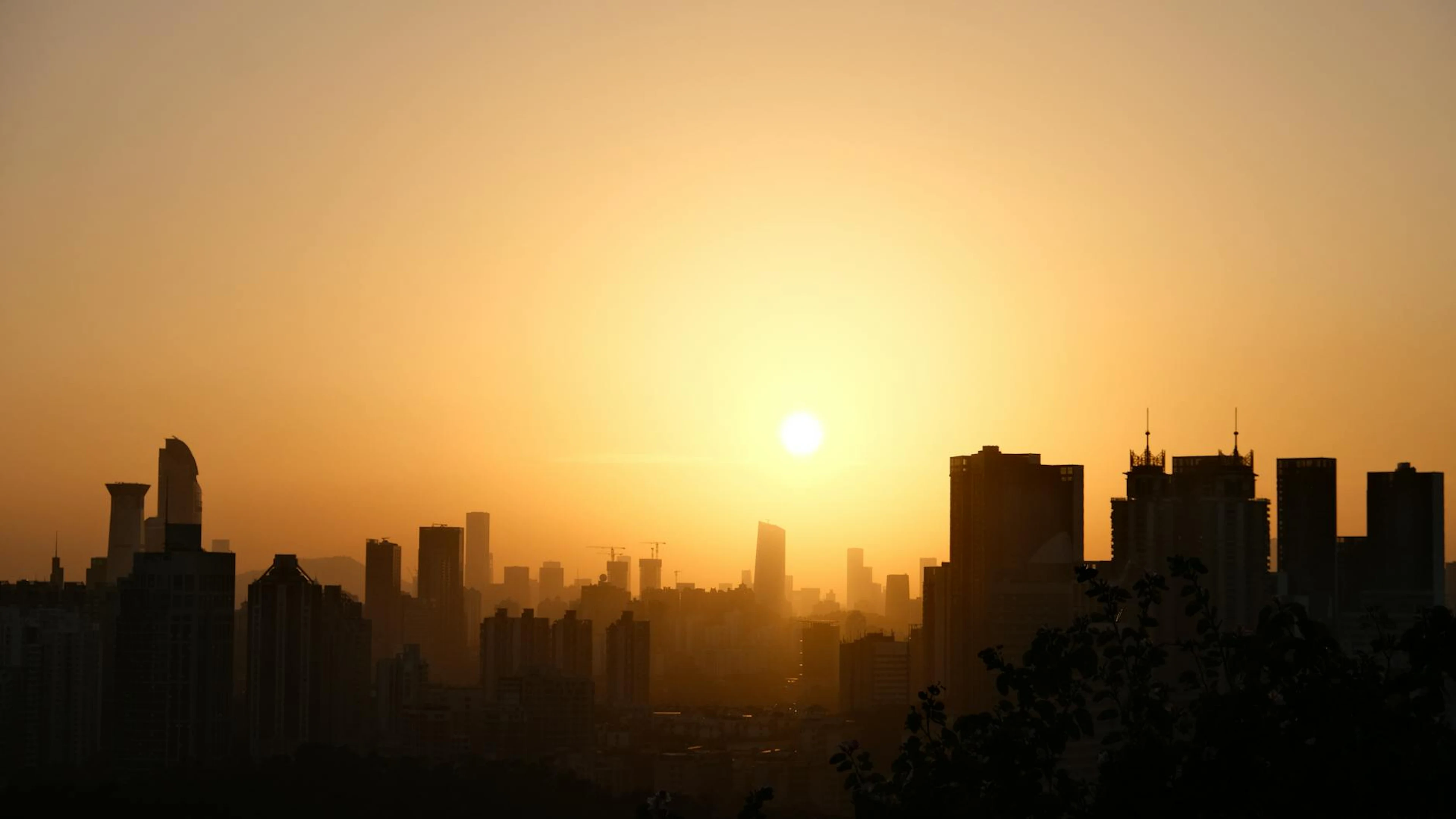 A breathtaking silhouette of a city skyline at sunrise, capturing the glowing ho - free 4K Ultra HD city wallpaper for desktop