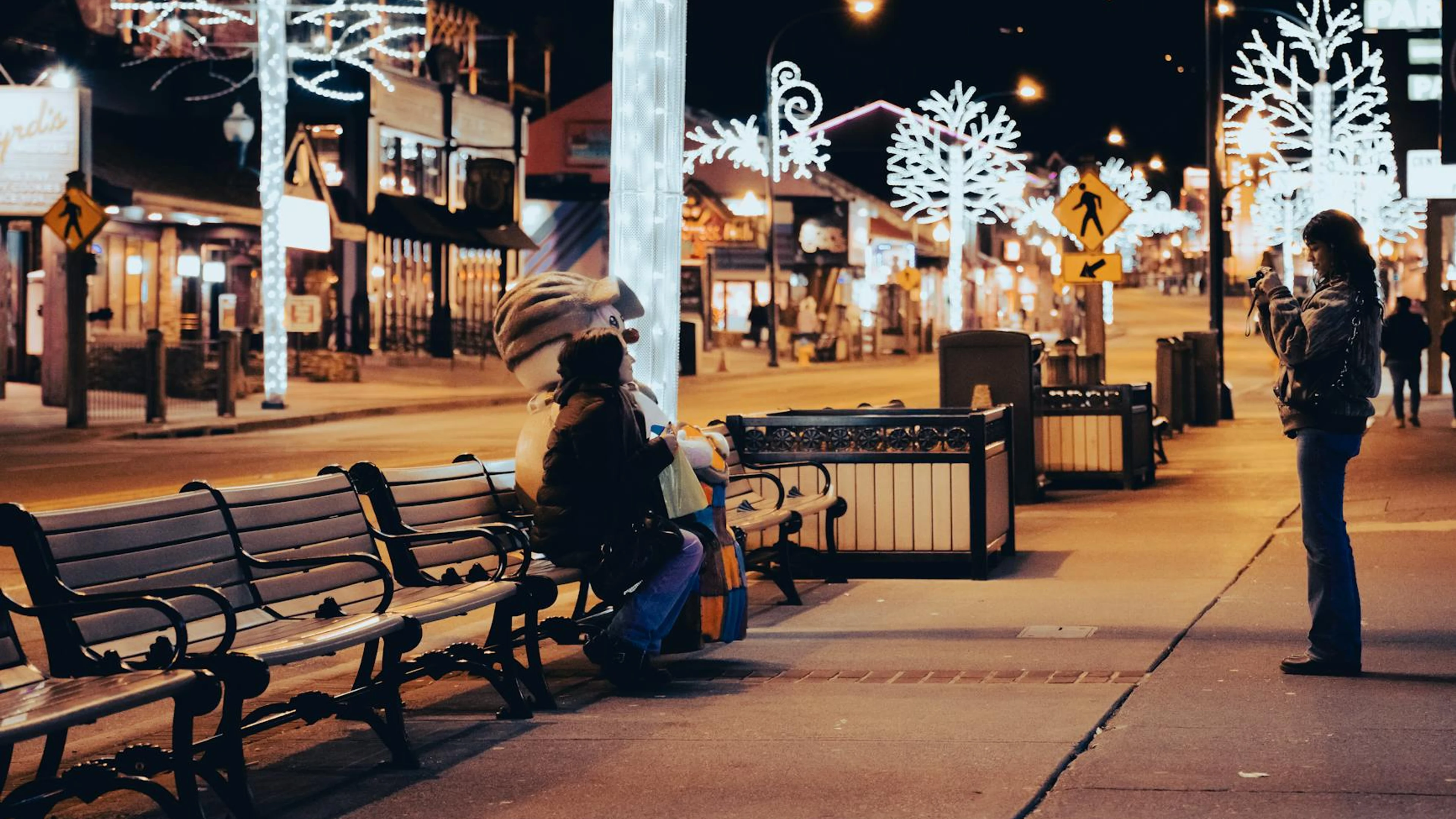 Capture of a vibrant night street scene with winter decorations, featuring two p - free 4K Ultra HD city wallpaper for desktop