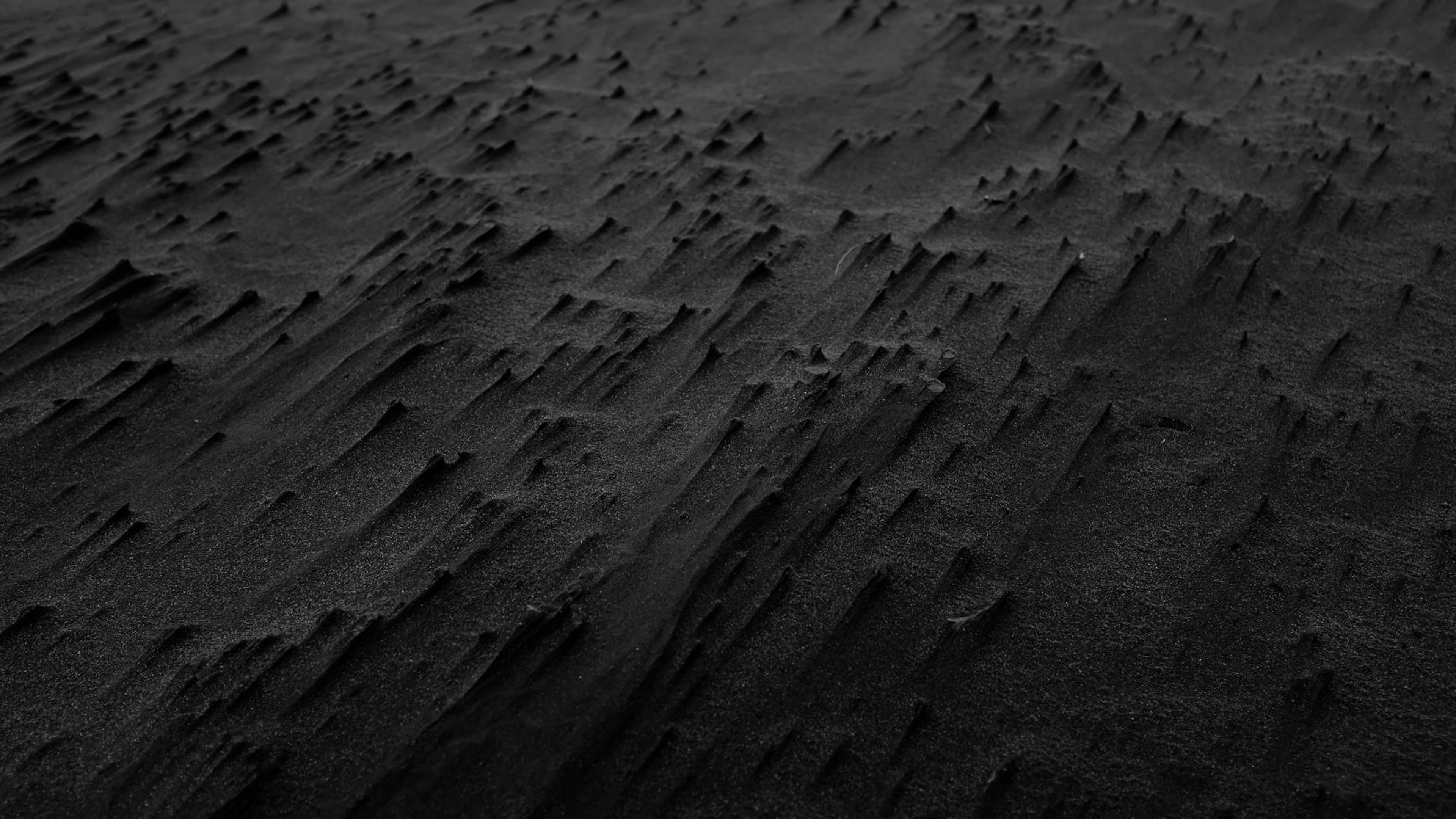 Abstract black sand texture creating a dramatic and moody background. - free 4K Ultra HD dark wallpaper for desktop