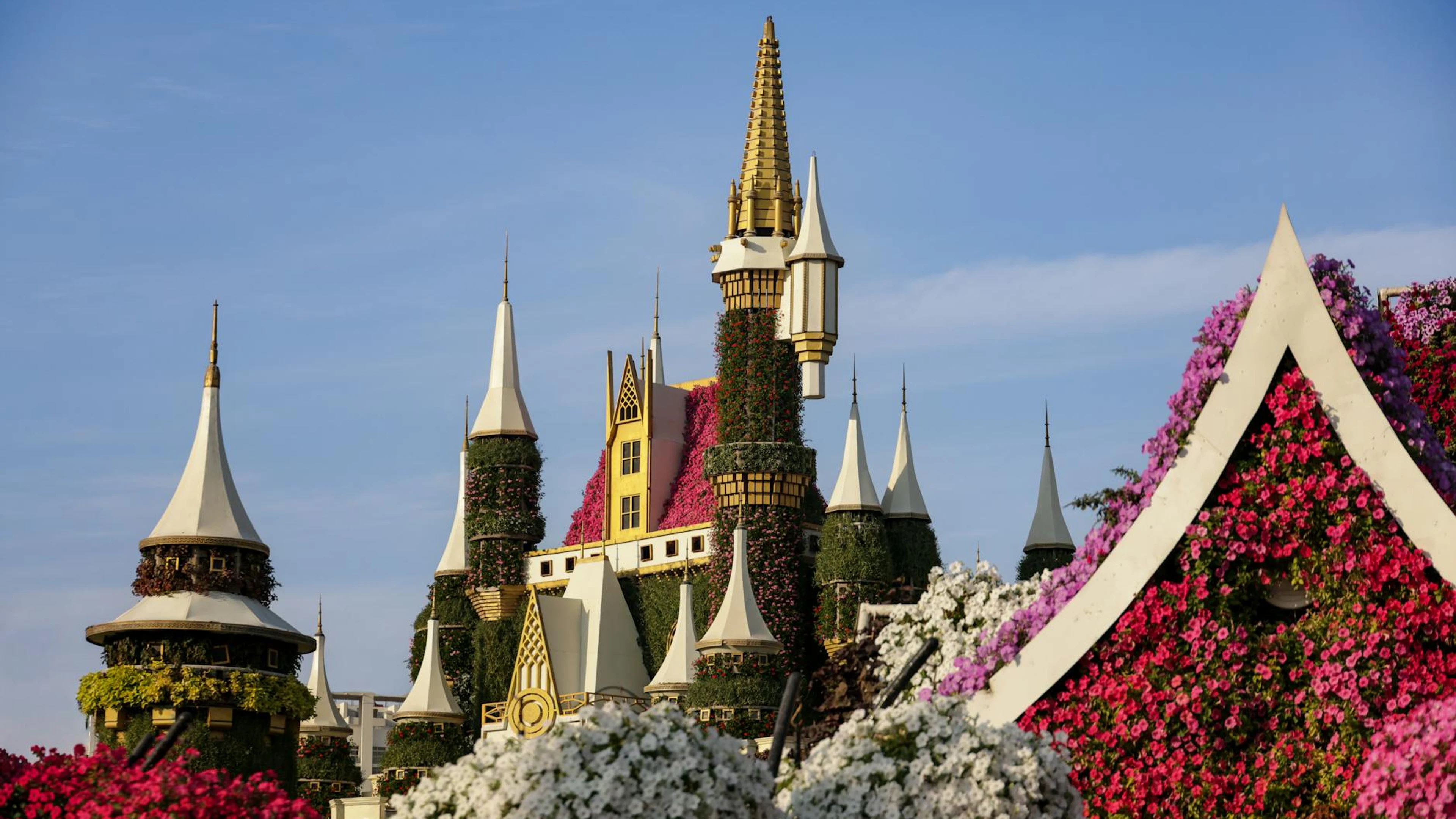 A stunning floral castle surrounded by vibrant blooms in a picturesque garden se - free 4K Ultra HD fantasy wallpaper for desktop