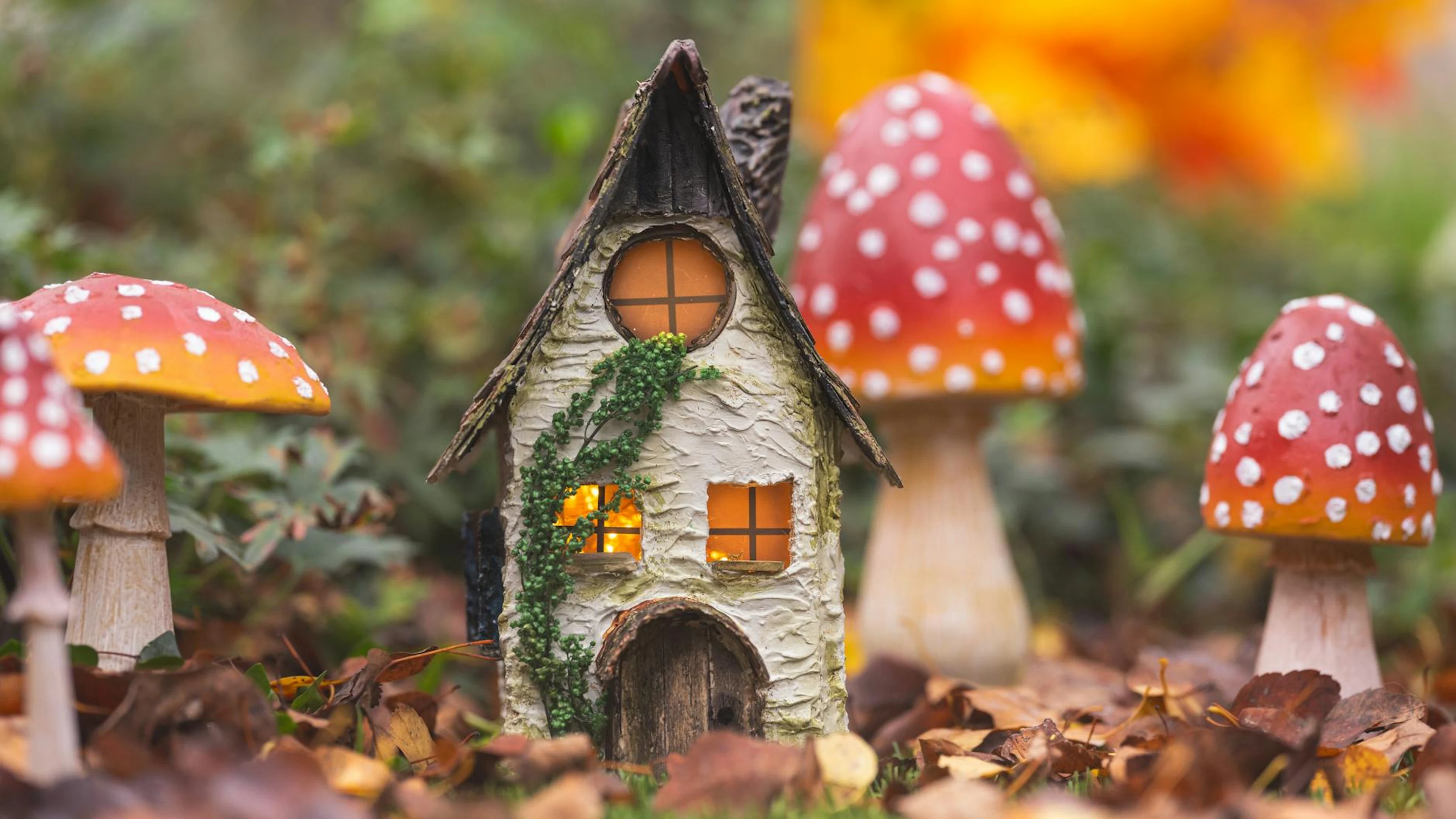 Fairy-tale inspired cottage amidst vibrant toadstools, set against an autumn bac - free 4K Ultra HD fantasy wallpaper for desktop