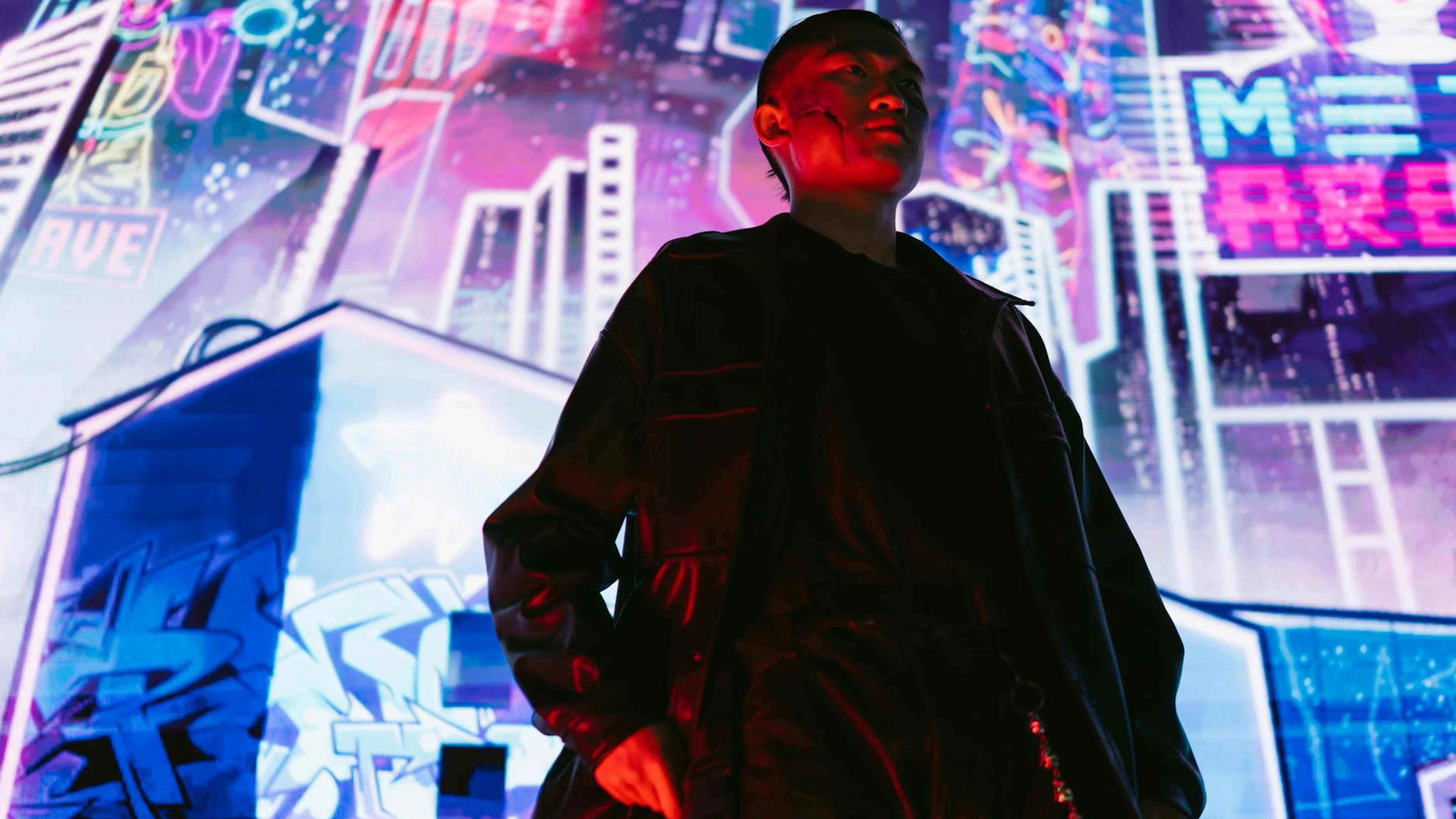 A man in a futuristic cyberpunk city with vibrant neon signs and lights. - free 4K Ultra HD gaming wallpaper for desktop