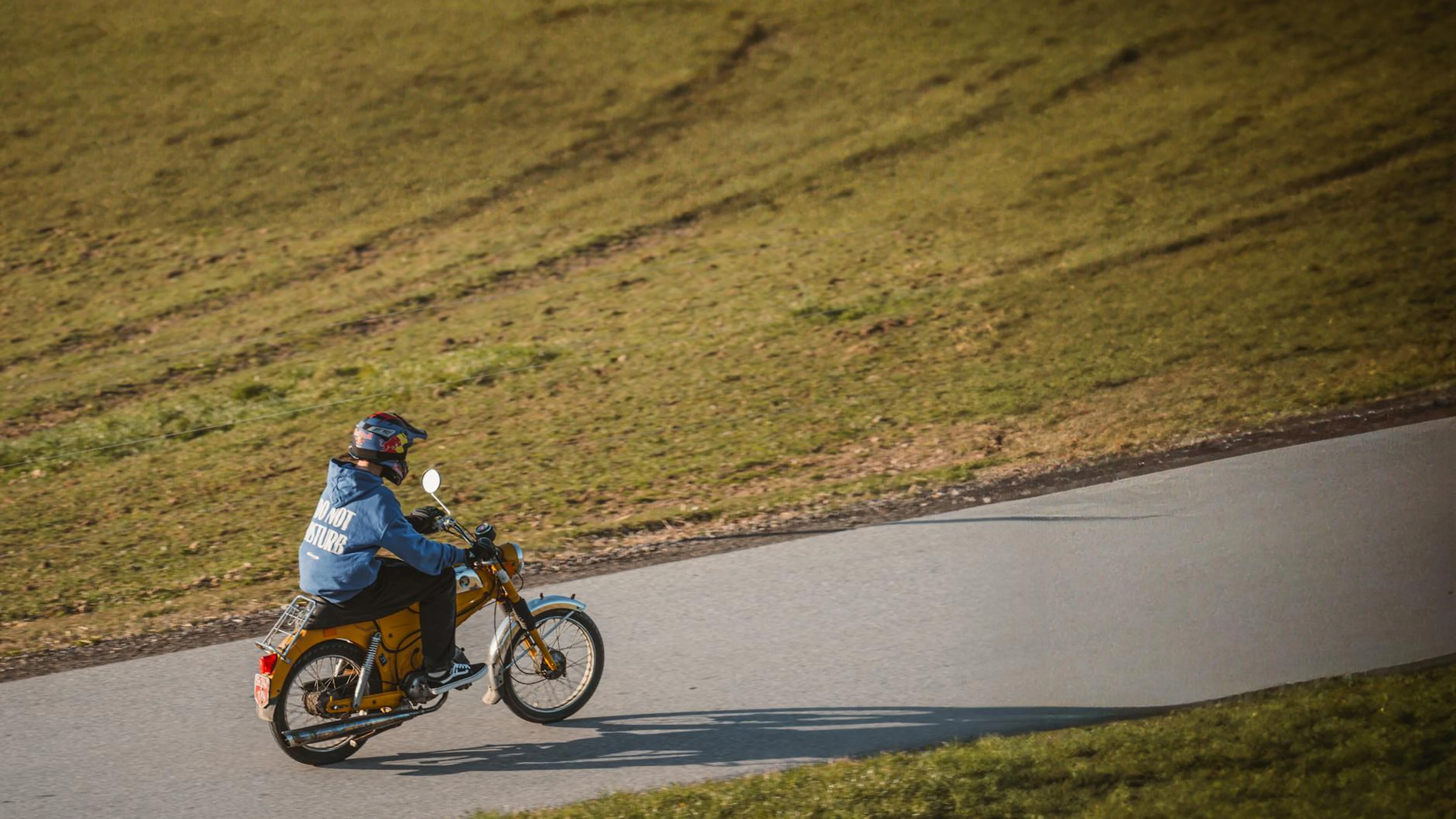 A motorcyclist riding through a sunny countryside road, capturing the essence of - free 4K Ultra HD gaming wallpaper for desktop