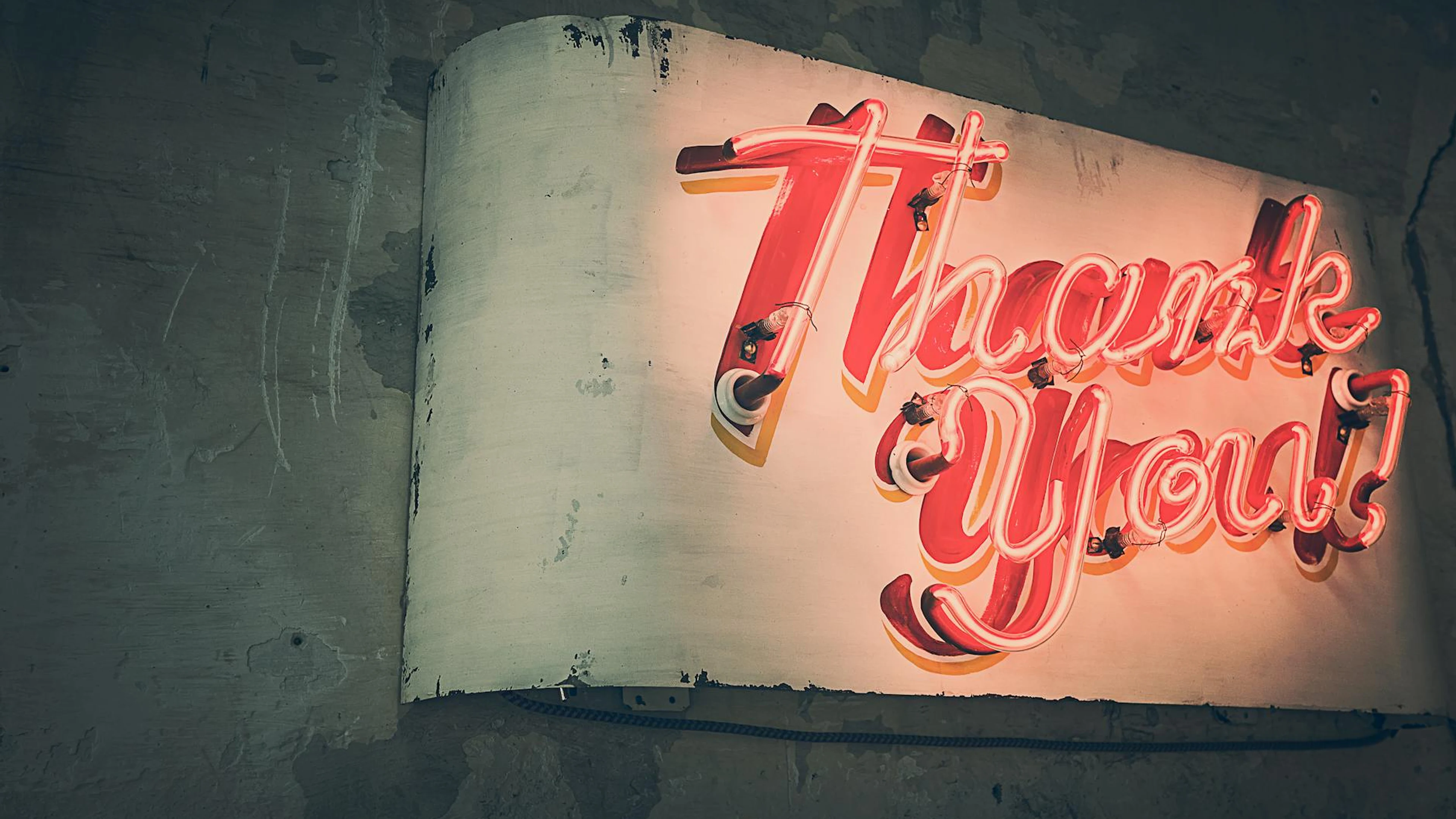 Retro neon 'Thank You' sign glowing warmly against a rustic wall, creating a nos - free 4K Ultra HD gaming wallpaper for desktop
