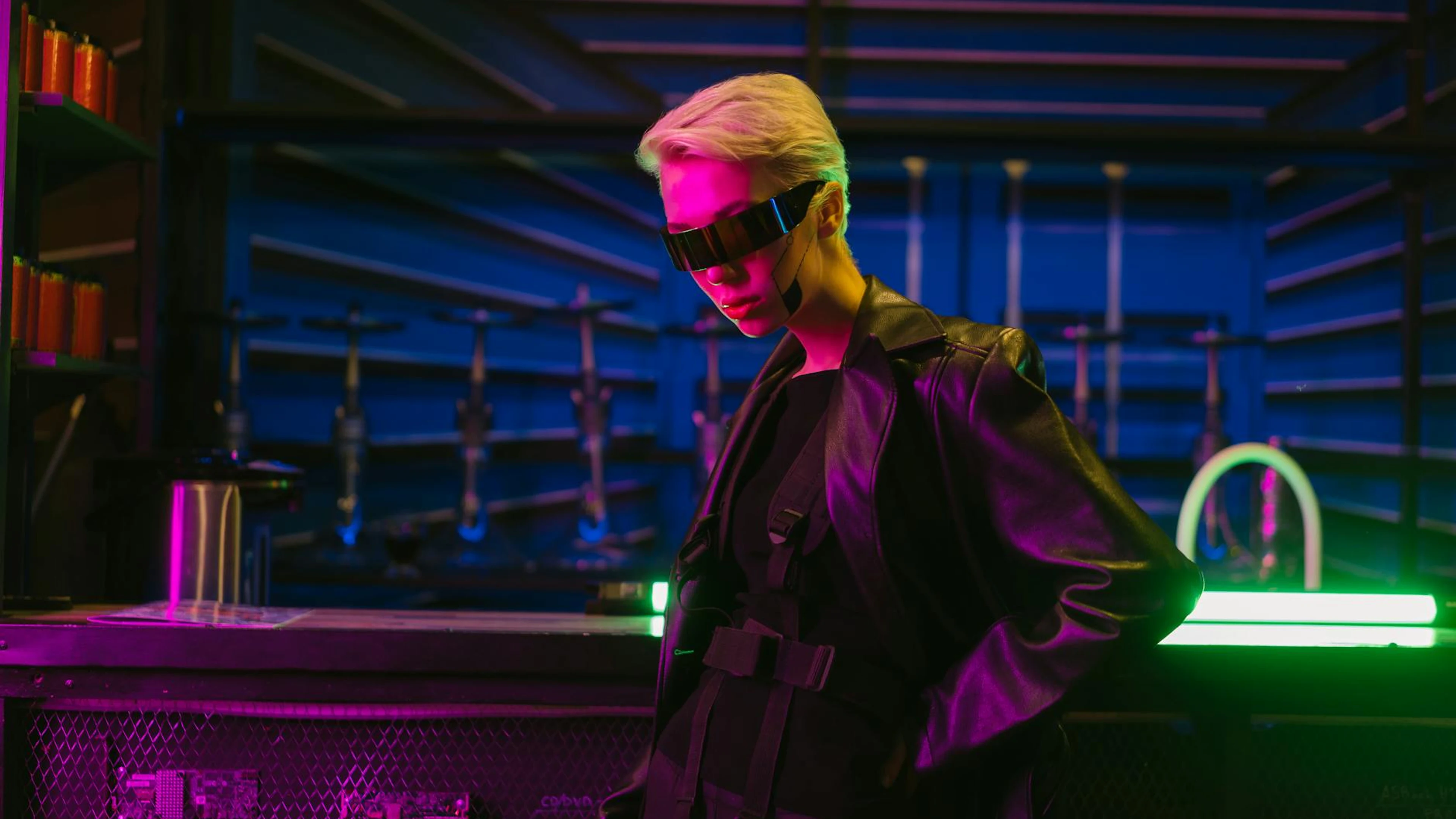 Stylish cyberpunk woman wearing futuristic sunglasses in neon-lit indoor setting - free 4K Ultra HD gaming wallpaper for desktop