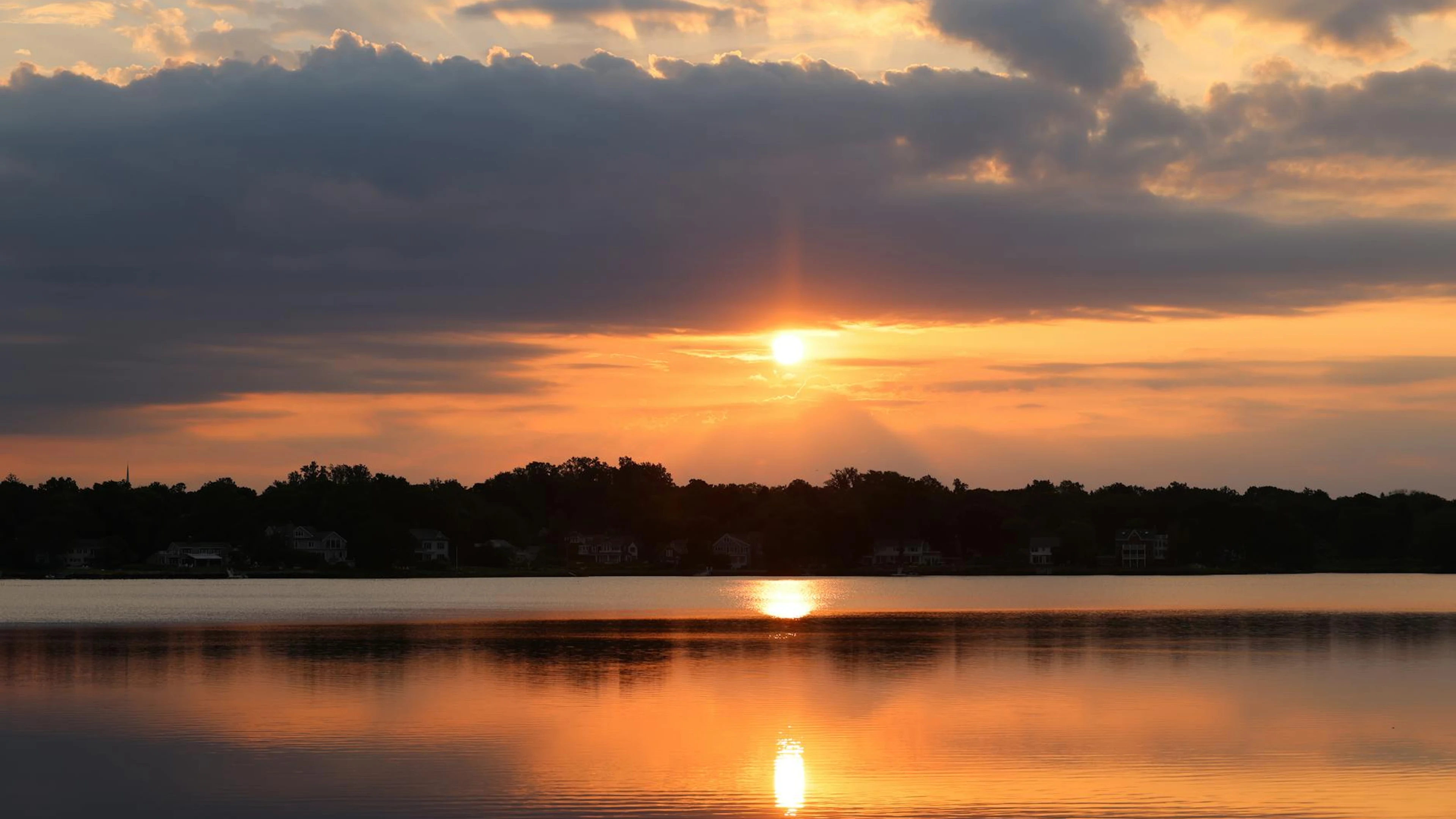 A breathtaking sunset reflecting over a tranquil lake, highlighting the serene b - free 4K Ultra HD lake wallpaper for desktop