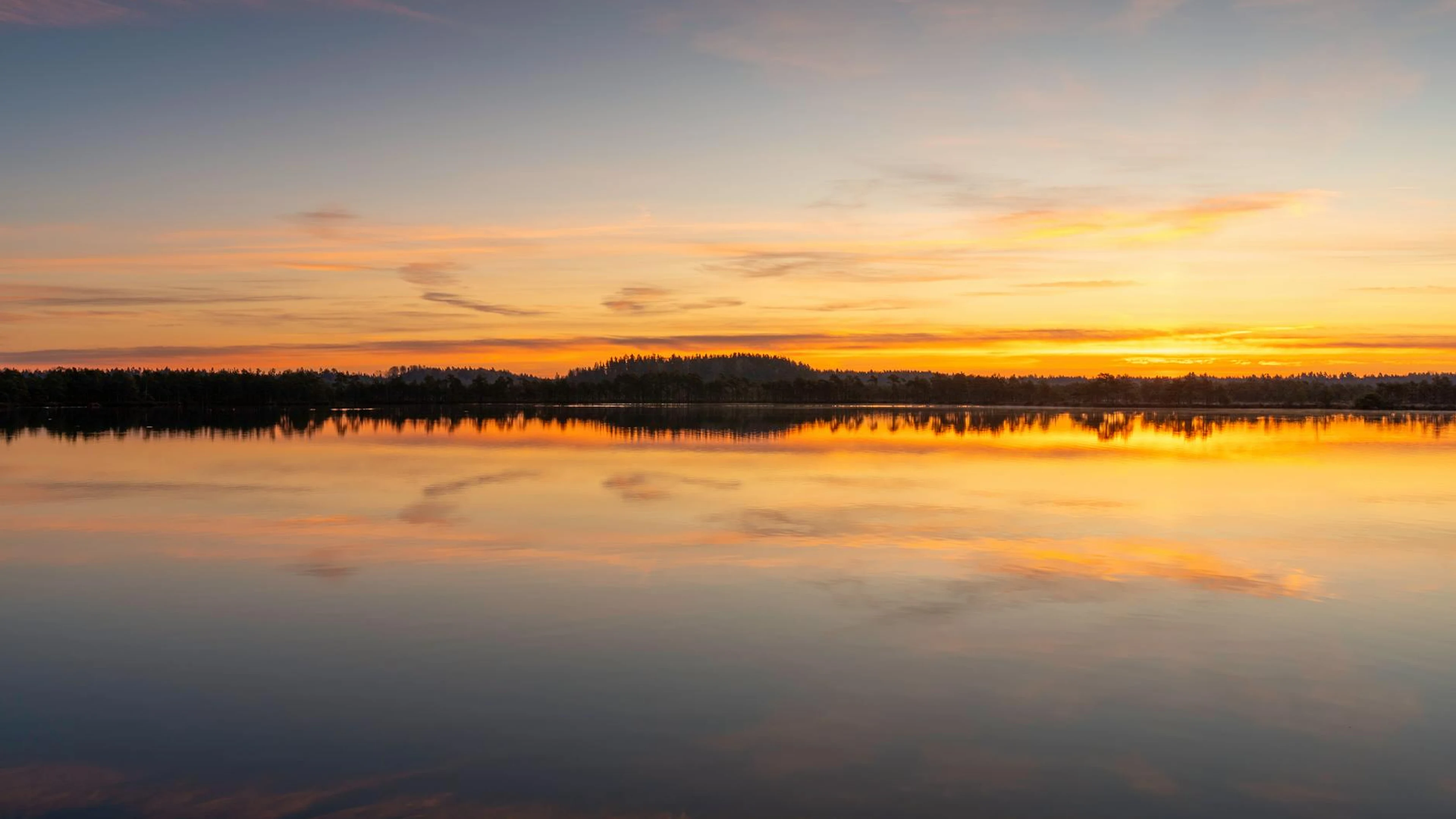 Stunning sunset reflection over a tranquil lake with vibrant skies. - free 4K Ultra HD lake wallpaper for desktop