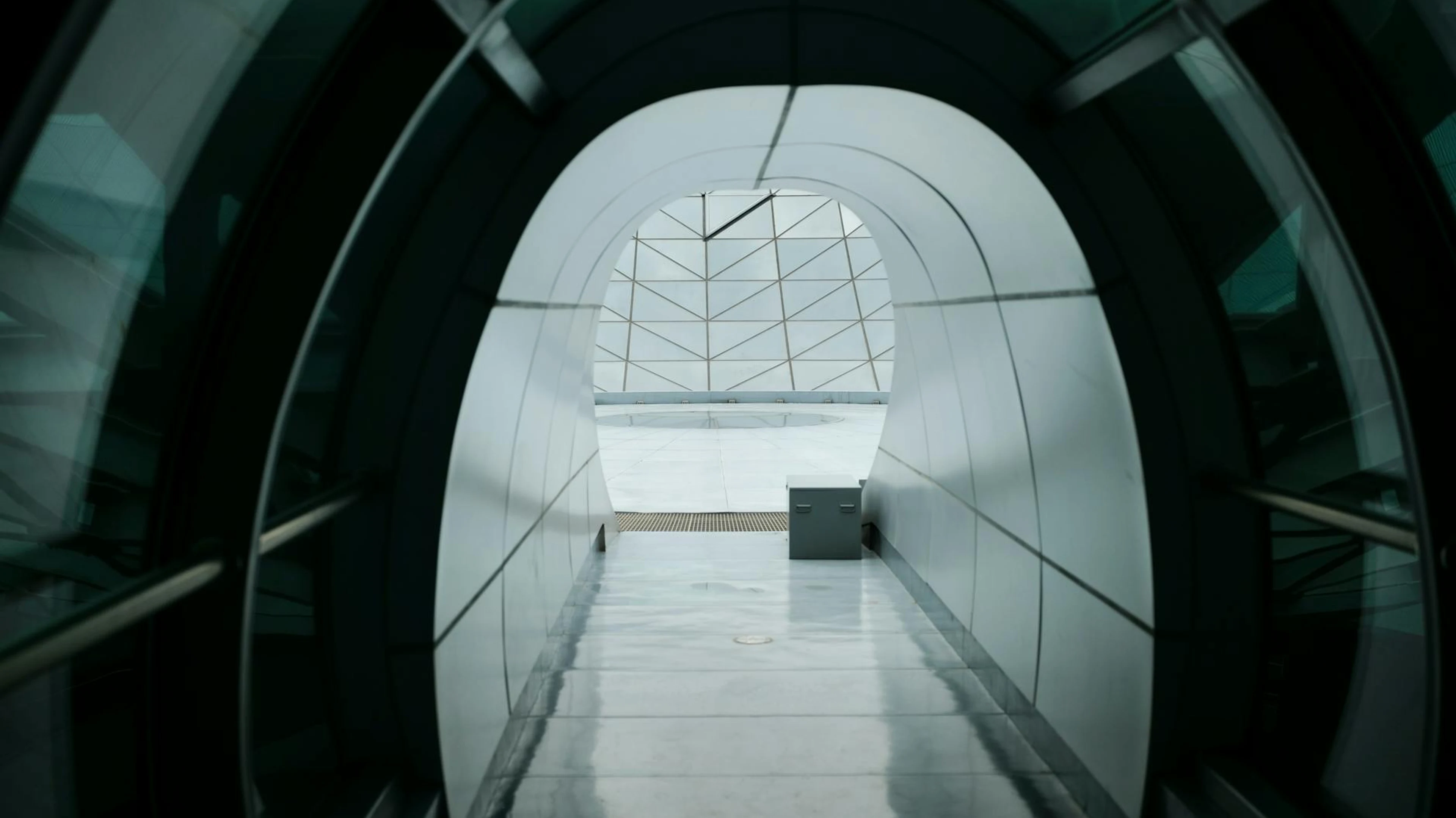 A modern, glass-arched corridor in Shanghai with a geometric design visible thro - free 4K Ultra HD minimal wallpaper for desktop