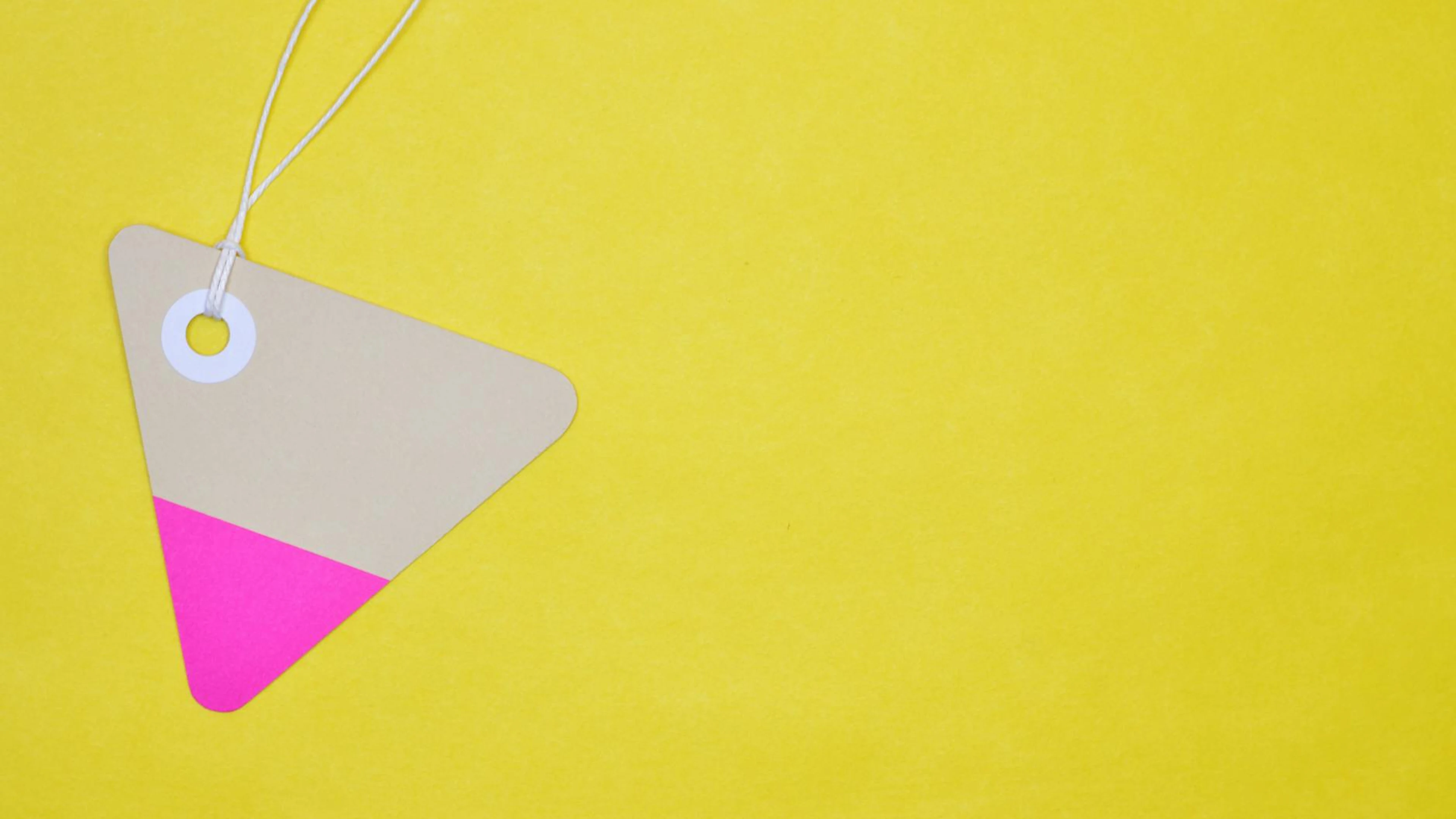 A simple, triangular card with a string on a vibrant yellow backdrop, ideal for - free 4K Ultra HD minimal wallpaper for desktop