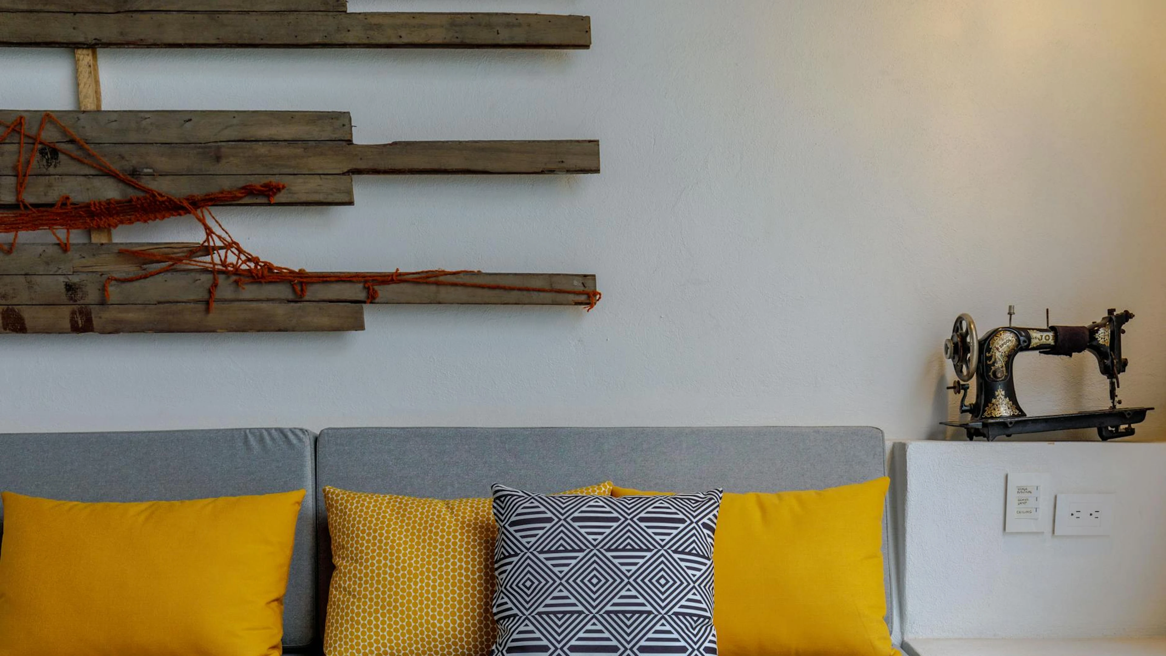 Contemporary interior with vibrant pillows, artistic wall decor, and vintage sew - free 4K Ultra HD minimal wallpaper for desktop