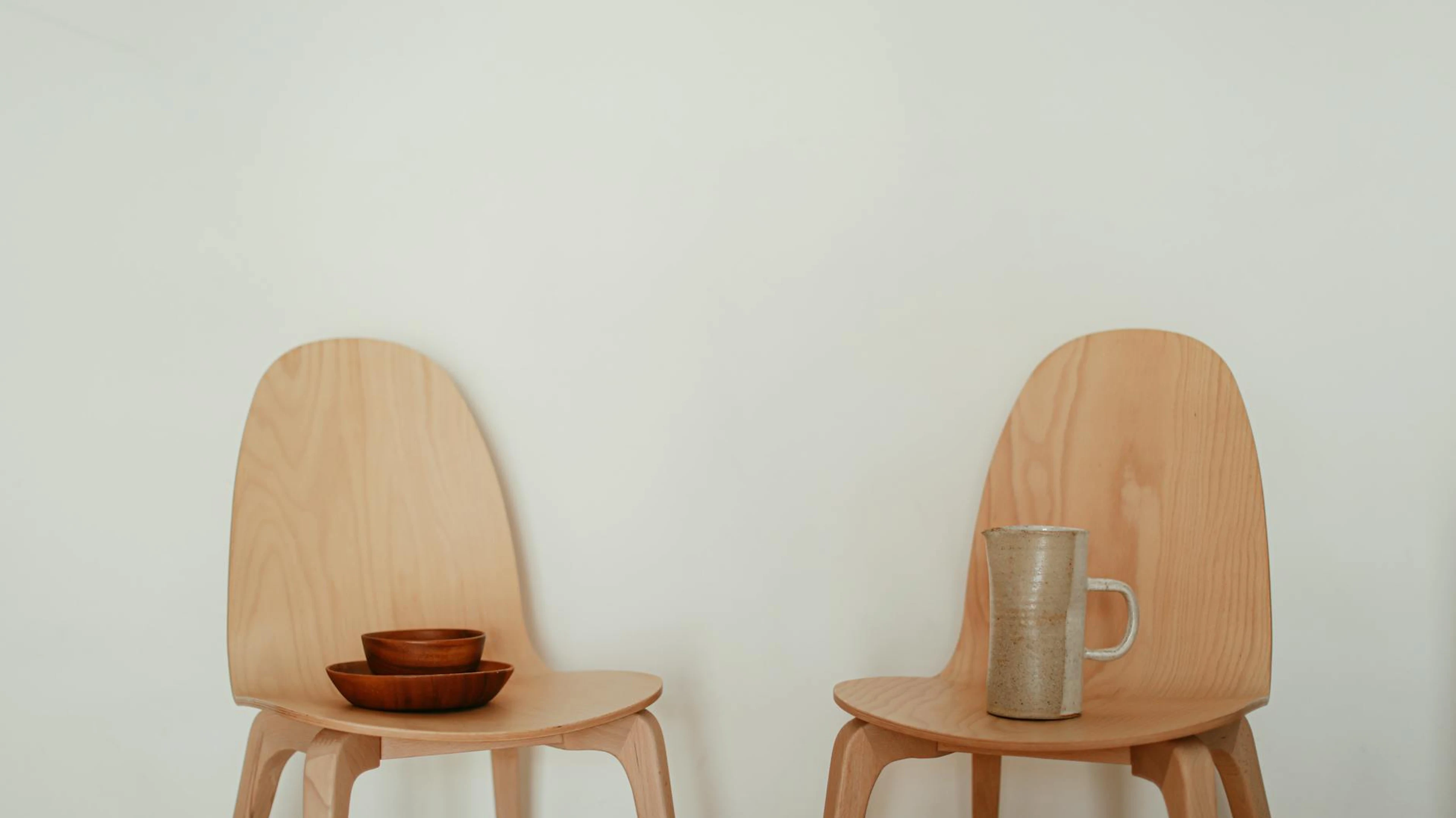 Two minimalist wooden chairs with a ceramic mug and bowls create a calm, modern - free 4K Ultra HD minimal wallpaper for desktop