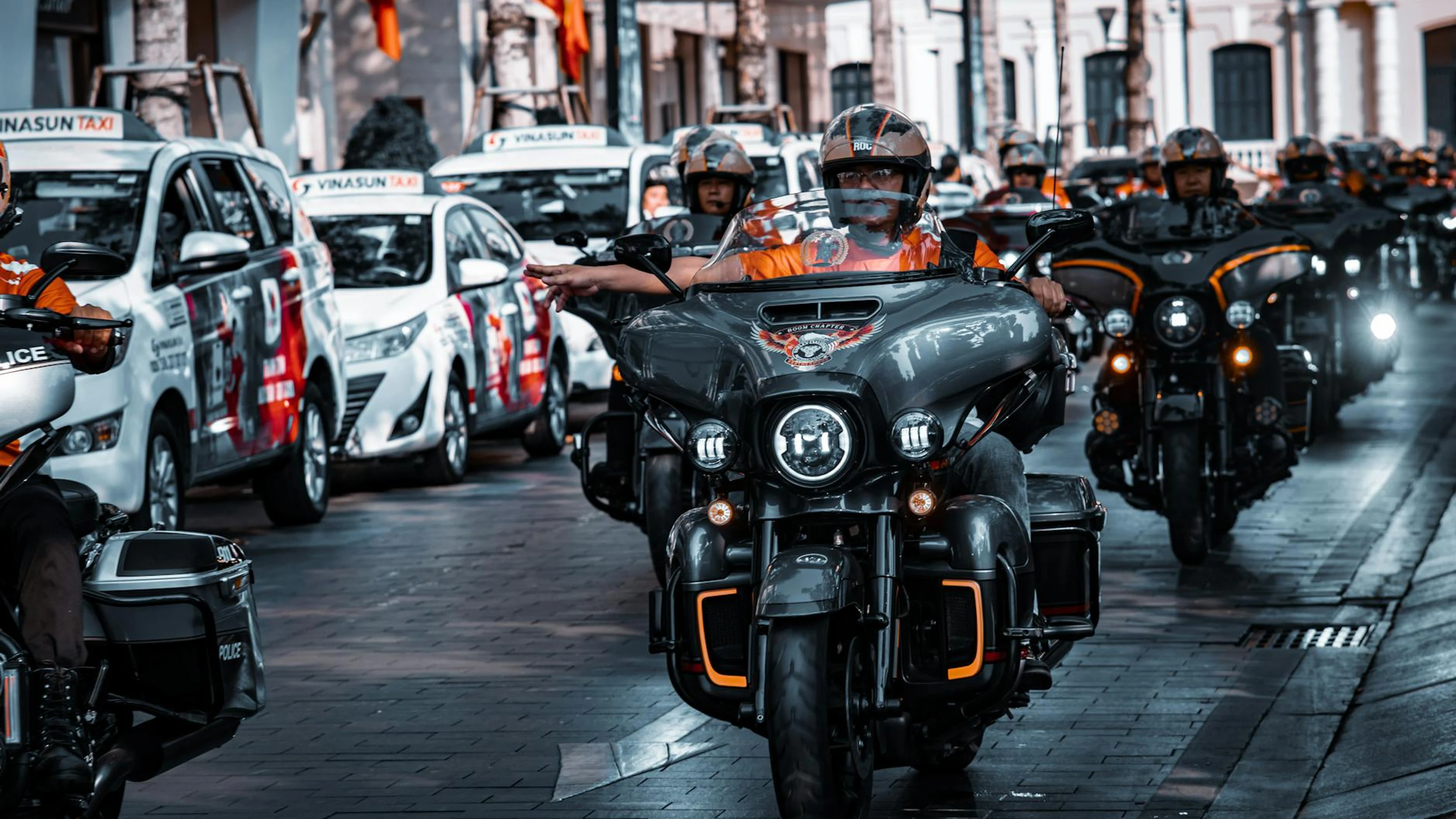 A group of bikers riding Harley-Davidson motorcycles on an urban street, capture - free 4K Ultra HD motorcycle wallpaper for desktop