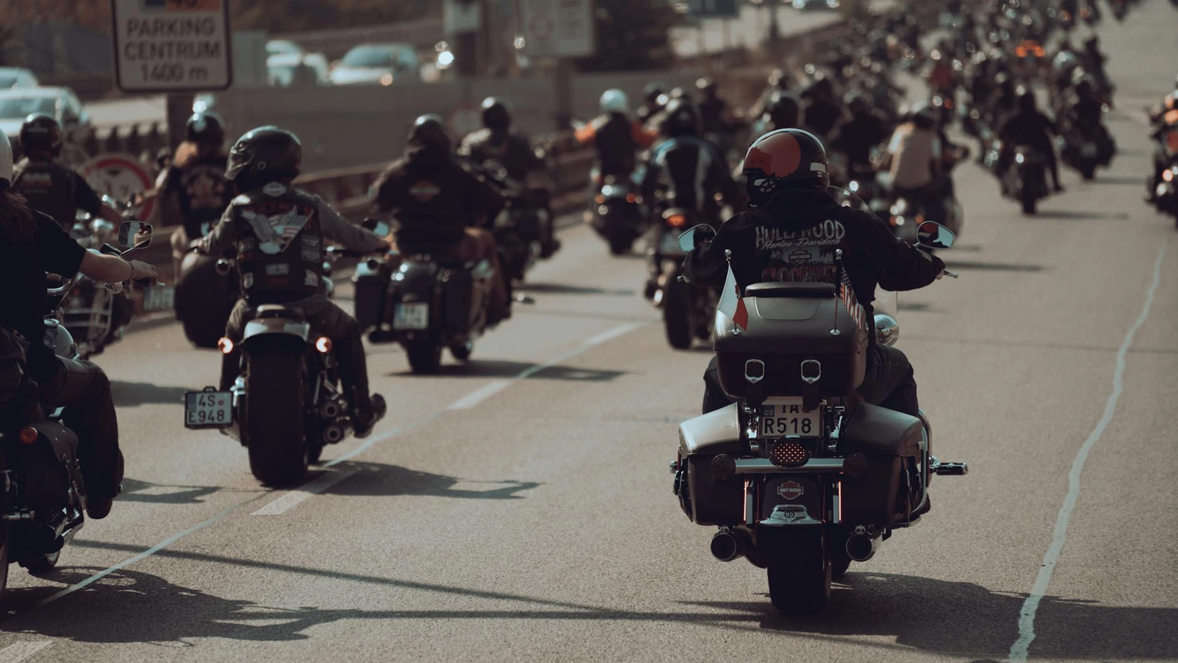 A large group of motorcyclists riding their bikes down a city highway, showcasin - free 4K Ultra HD motorcycle wallpaper for desktop