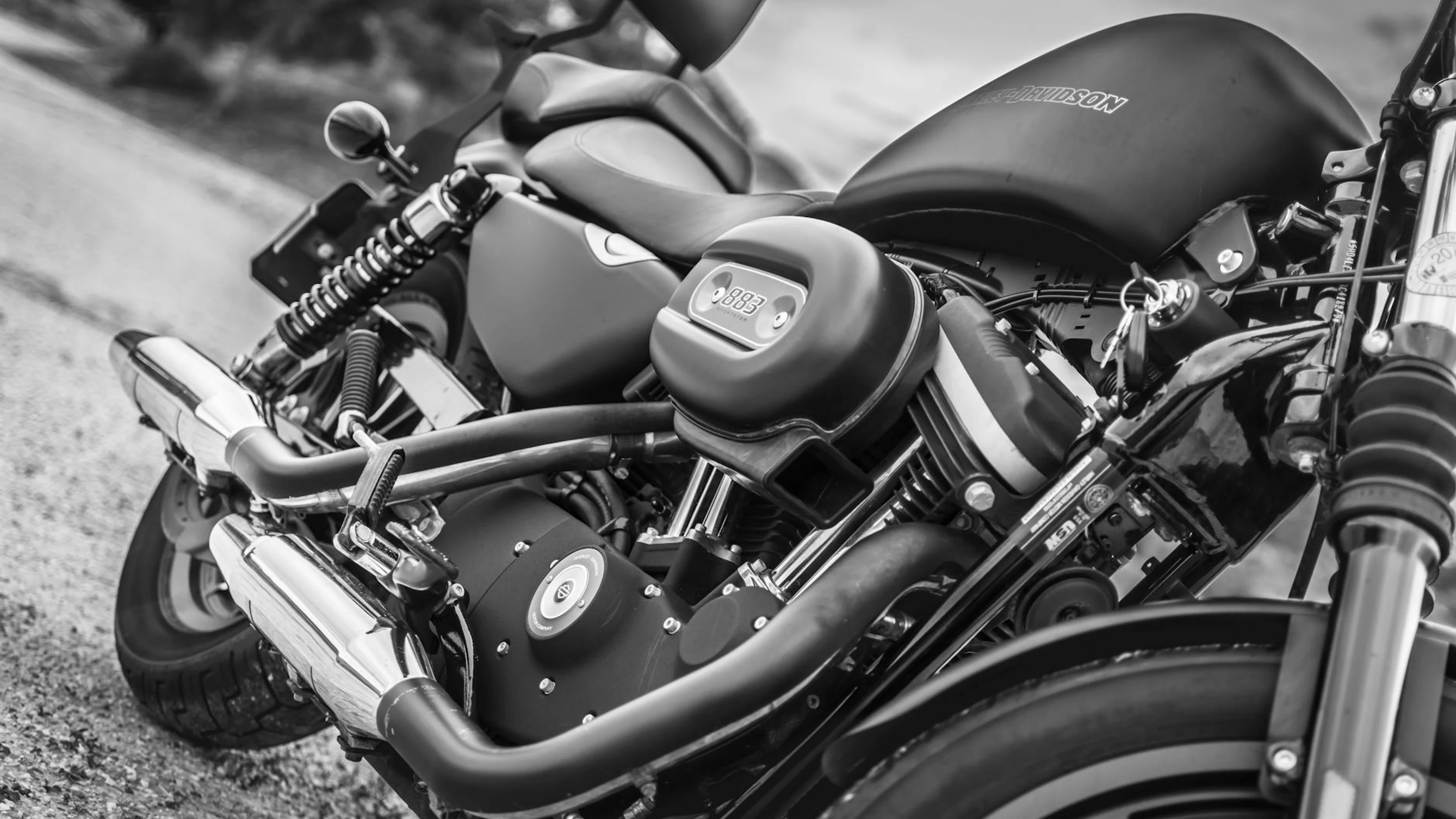 Black and white image highlighting a detailed view of a Harley Davidson motorcyc - free 4K Ultra HD motorcycle wallpaper for desktop