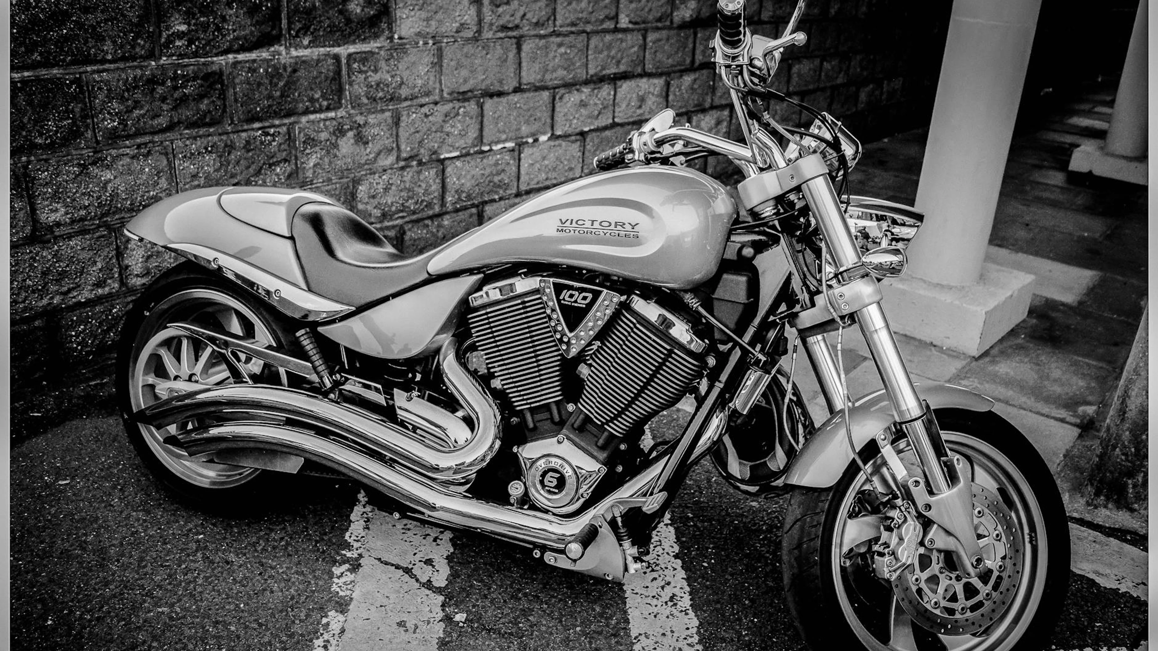 Black and white image of a Victory motorcycle parked in Torbay, England. - free 4K Ultra HD motorcycle wallpaper for desktop