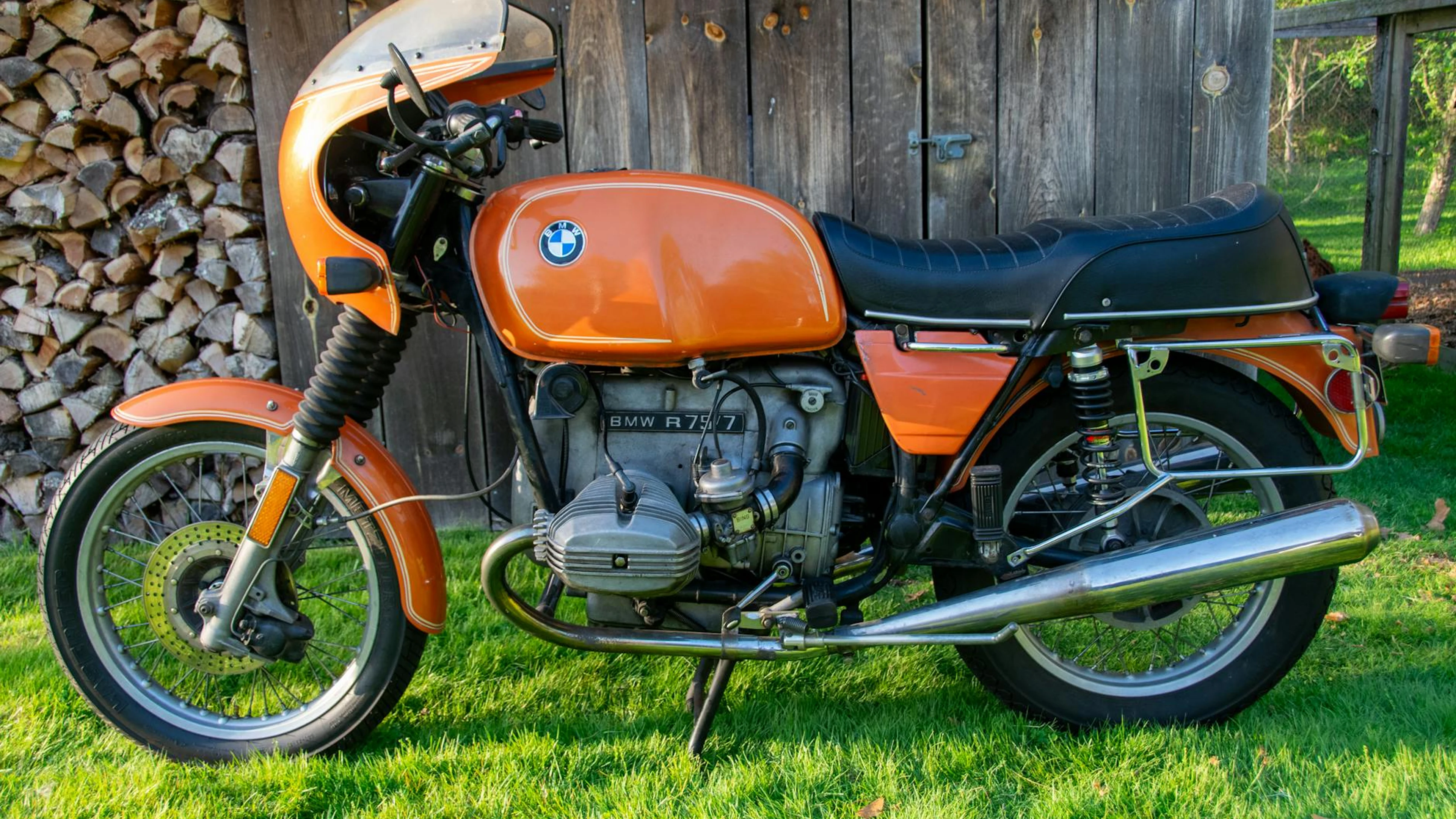 Classic BMW motorcycle with orange retro design parked outdoors. - free 4K Ultra HD motorcycle wallpaper for desktop