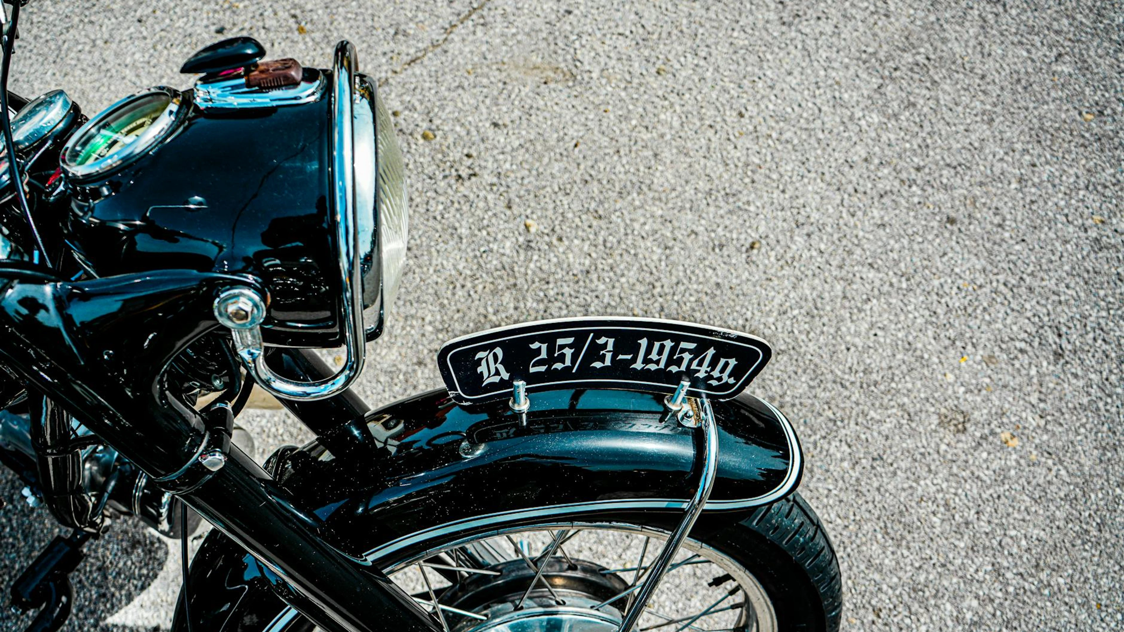 Close-up of a vintage motorcycle headlight and fender with plate detailing. - free 4K Ultra HD motorcycle wallpaper for desktop