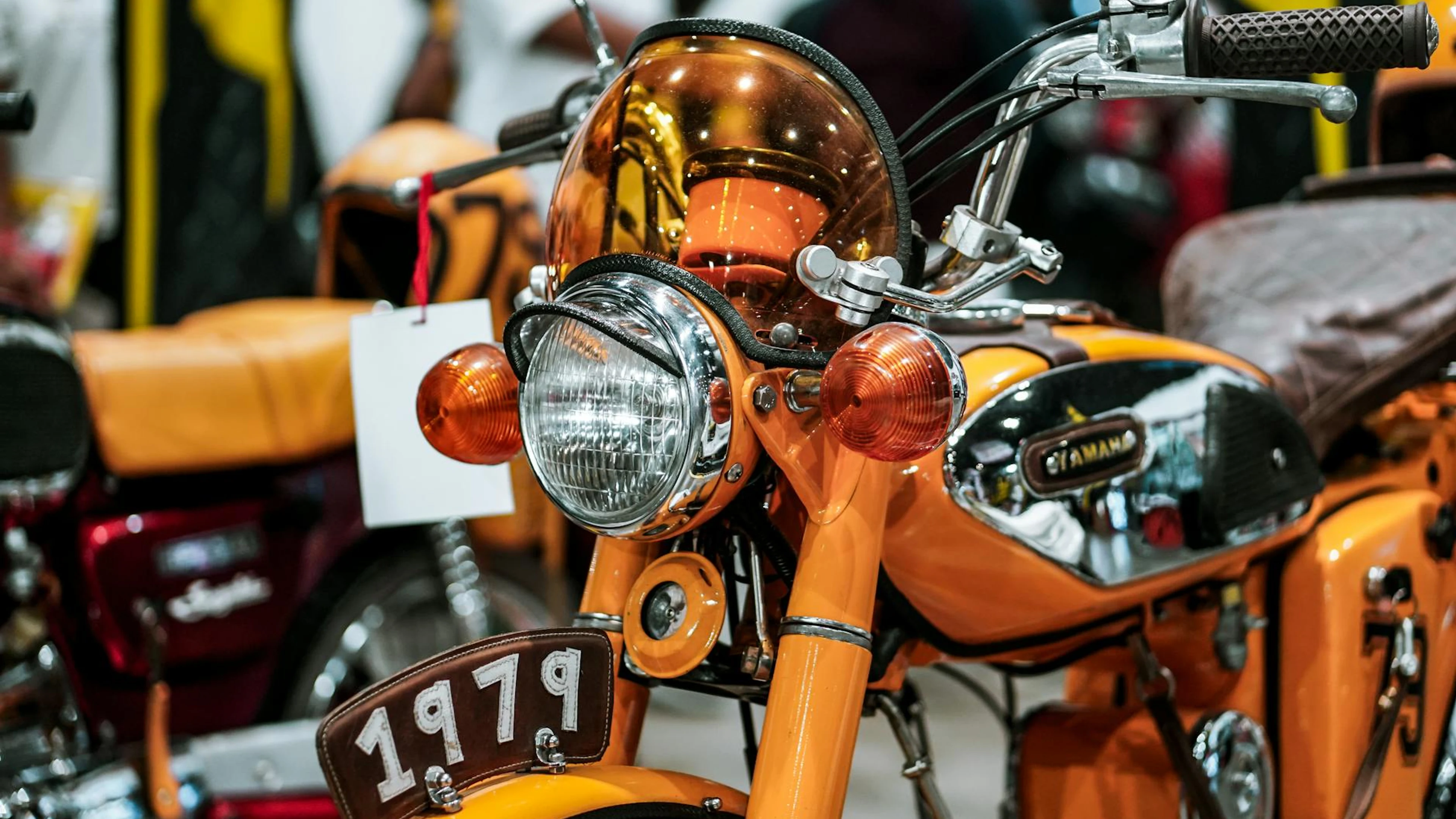 Detailed view of a classic 1979 Yamaha motorcycle at an exhibition. - free 4K Ultra HD motorcycle wallpaper for desktop