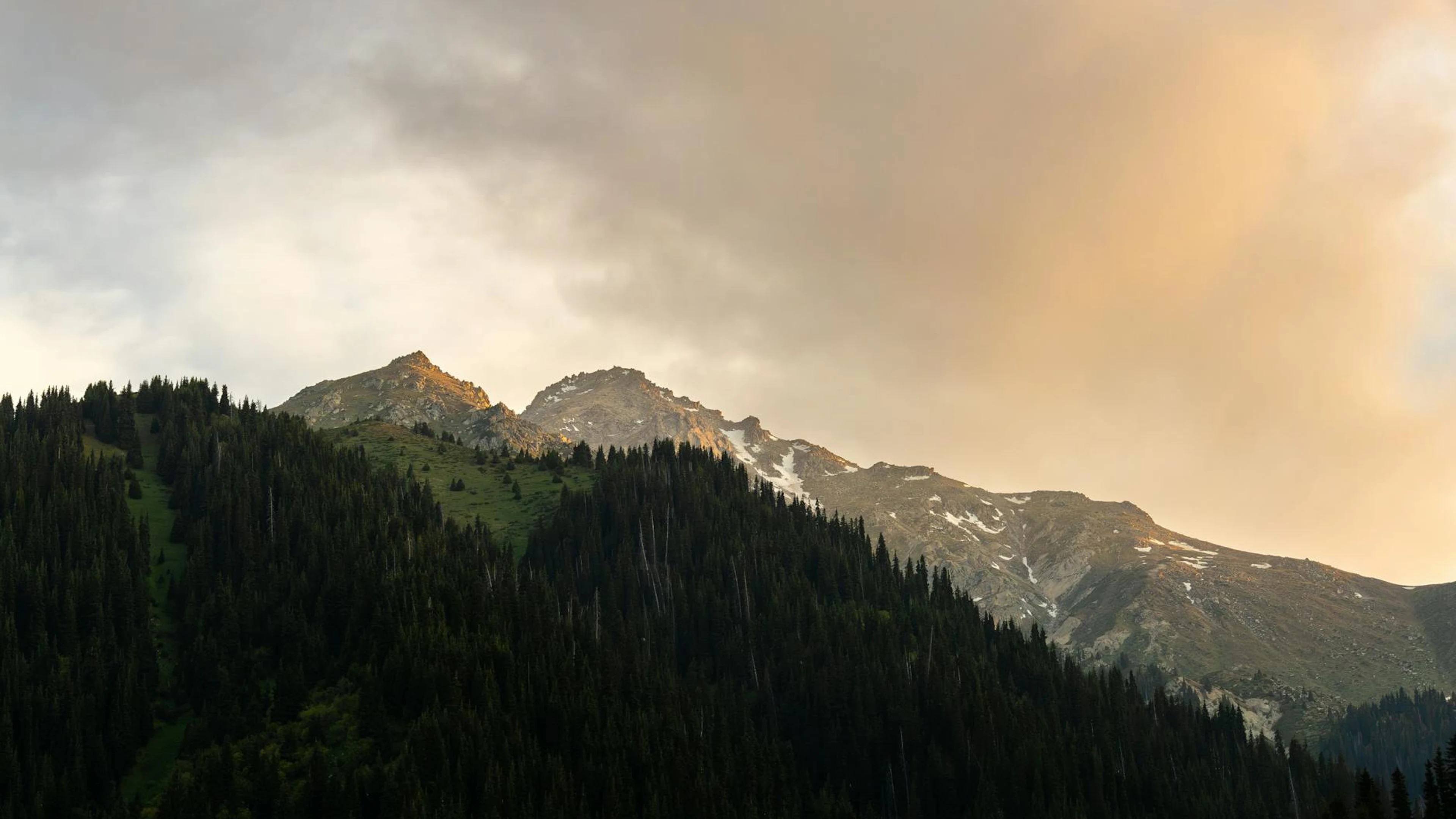 Captivating sunrise over snow-capped mountains in Almaty, showcasing nature's be - free 4K Ultra HD mountain wallpaper for desktop
