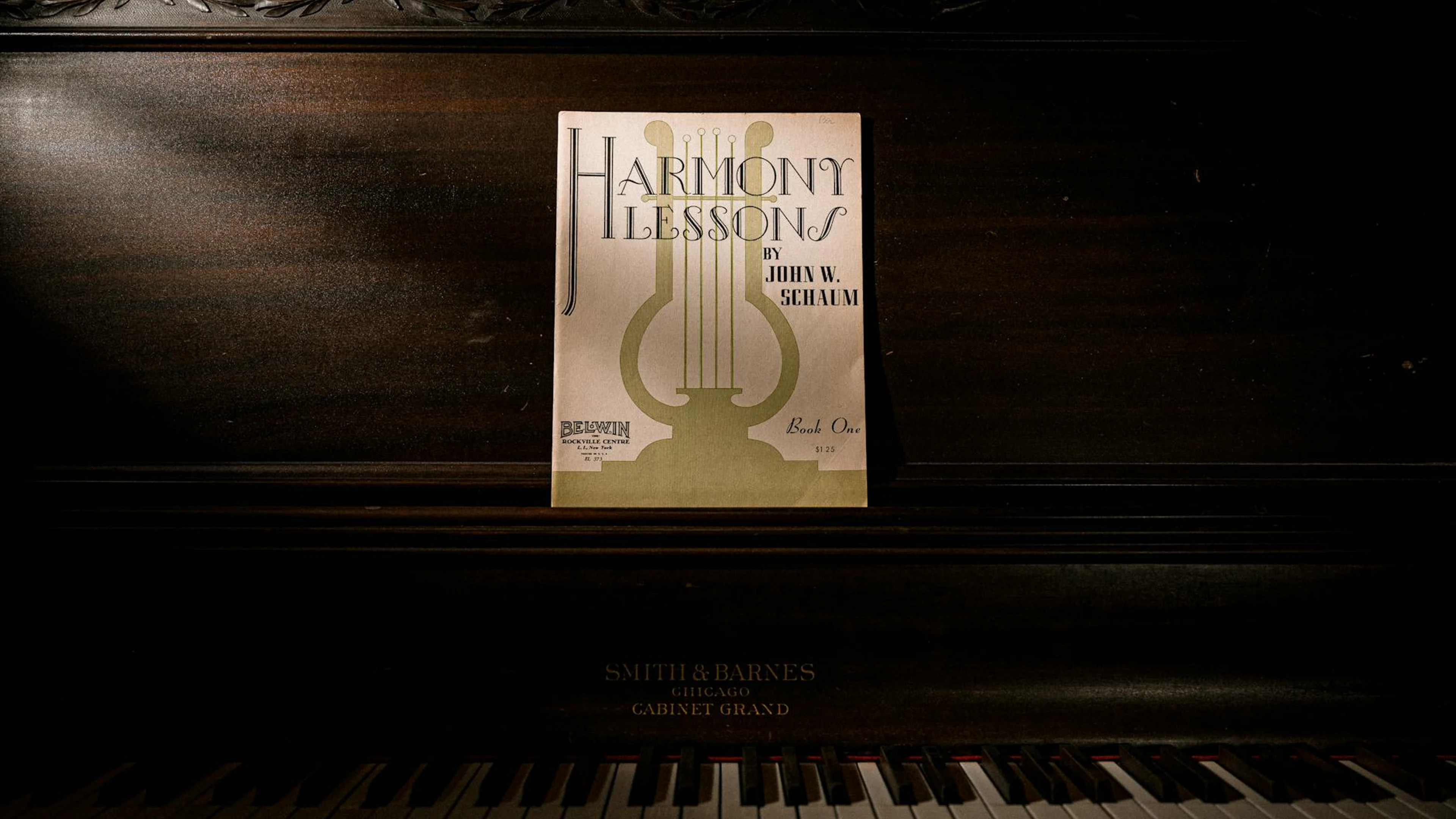 Dark, vintage piano with 'Harmony Lessons' sheet music, offering a classic and a - free 4K Ultra HD music wallpaper for desktop