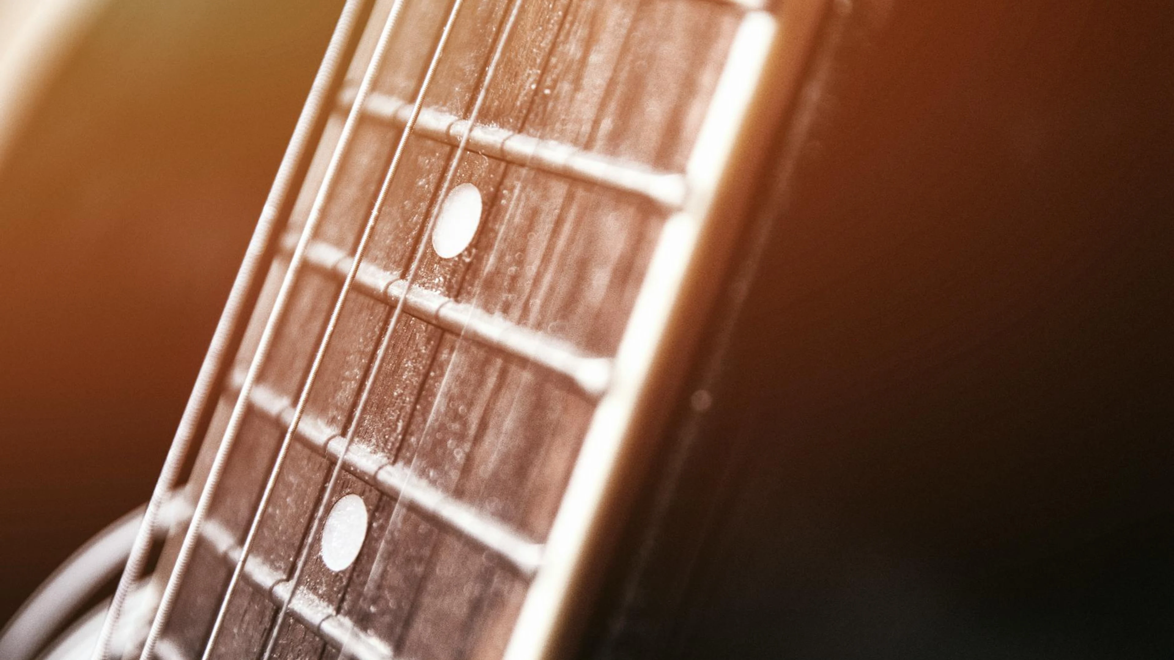Detailed view of acoustic guitar strings, highlighting the texture and craftsman - free 4K Ultra HD music wallpaper for desktop