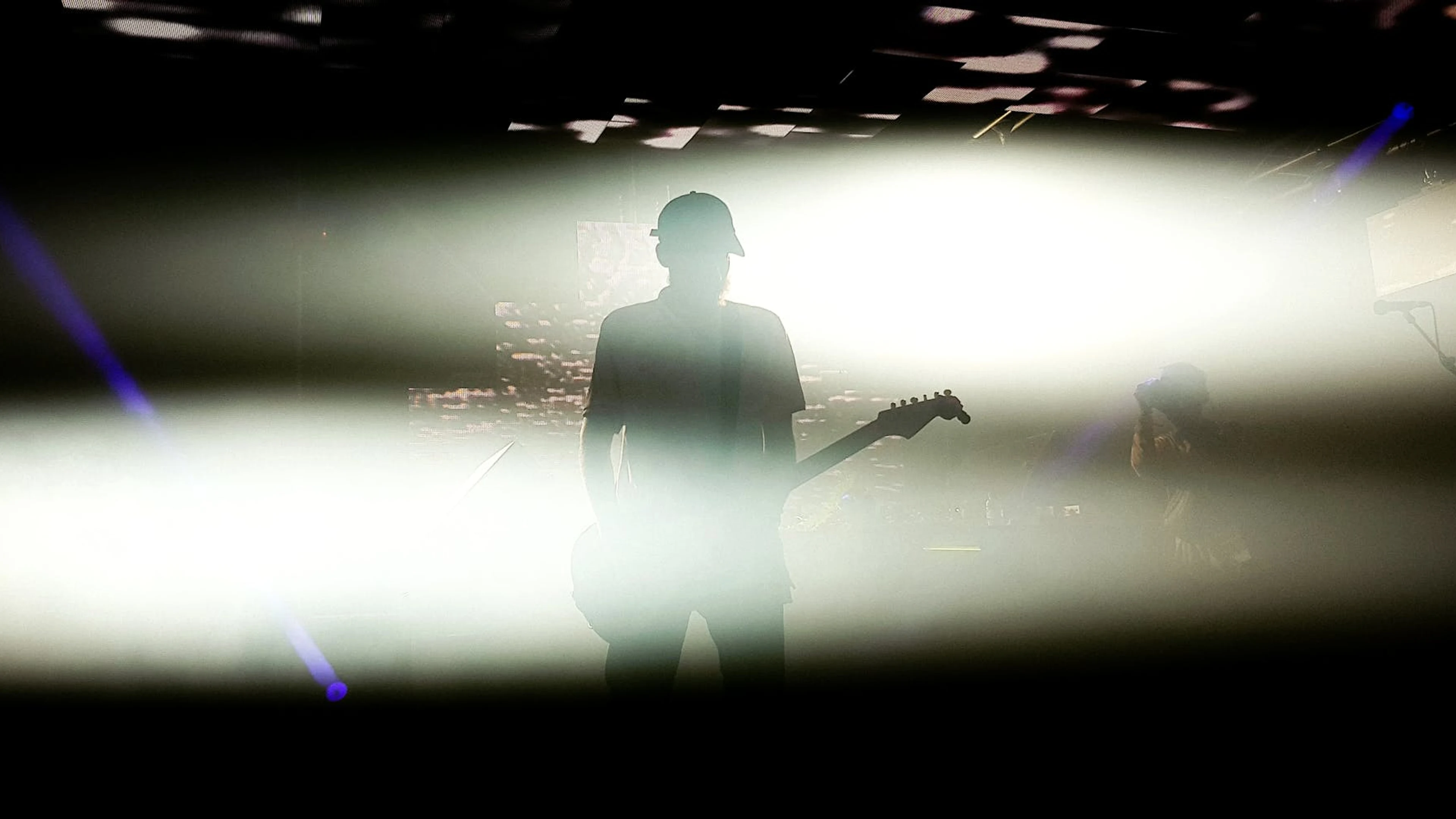 Silhouette of a guitarist performing under dramatic lighting, creating a strikin - free 4K Ultra HD music wallpaper for desktop
