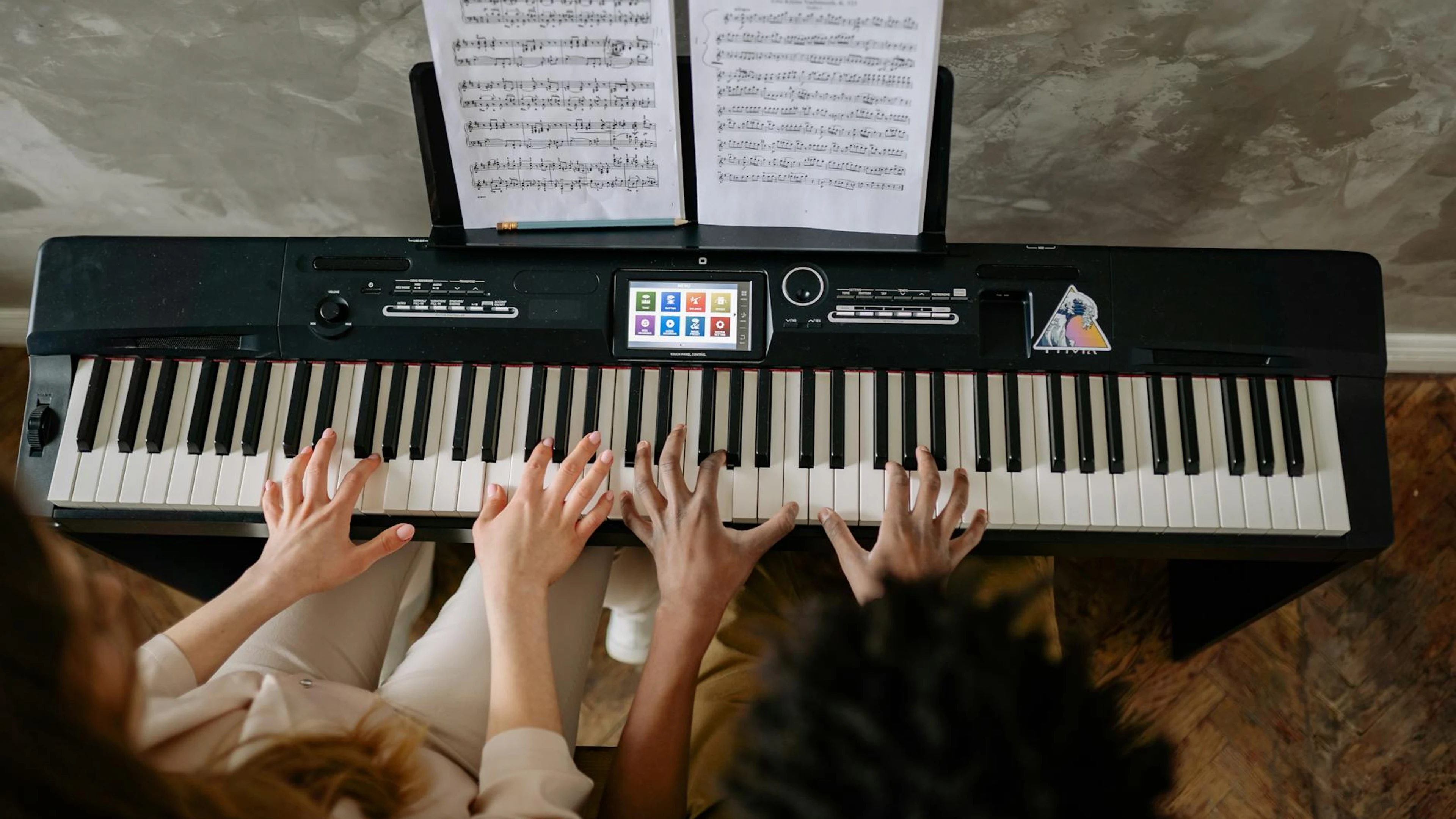 Teacher and student playing piano together for a hands-on learning experience. - free 4K Ultra HD music wallpaper for desktop