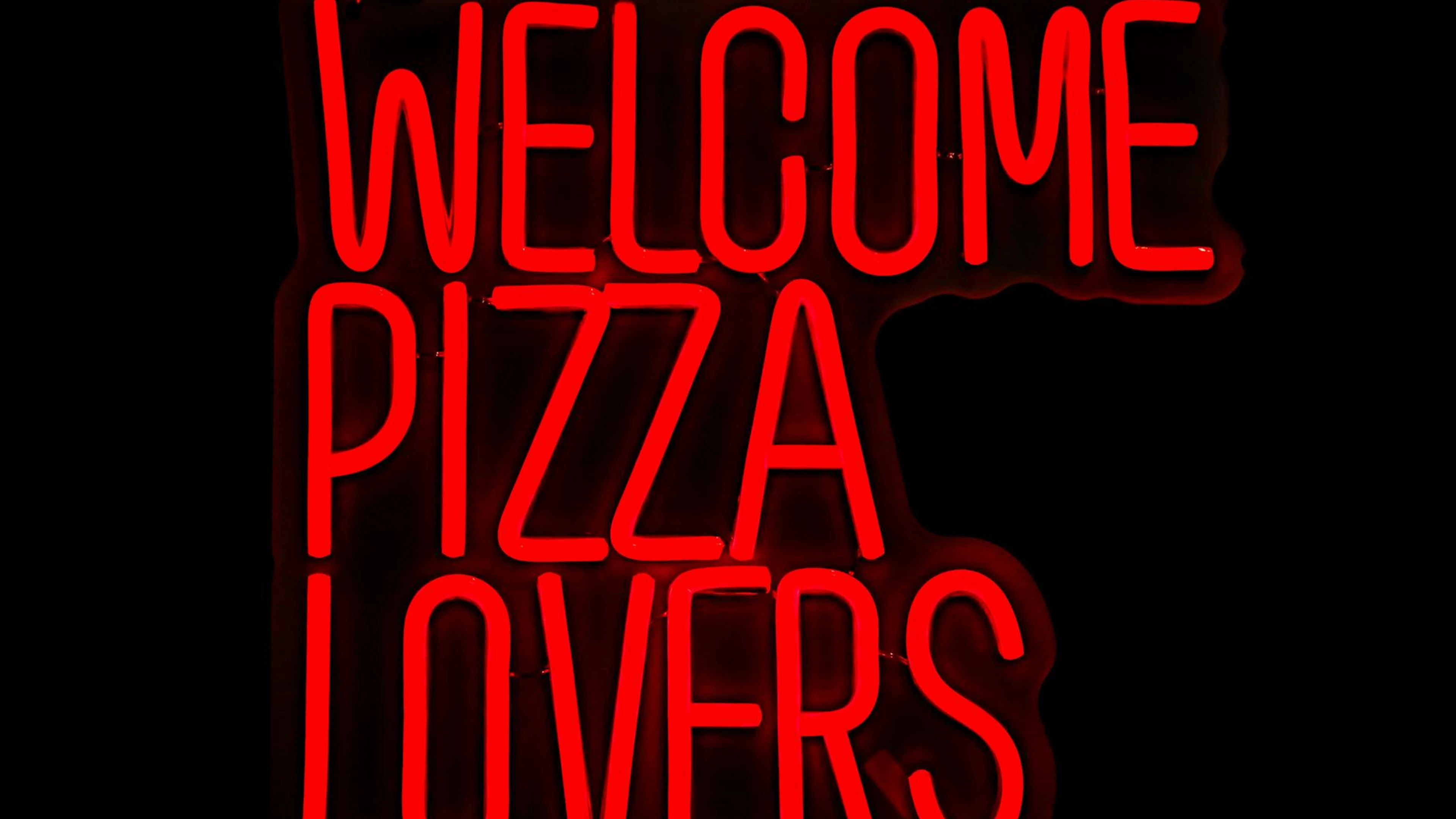 Bright red neon sign welcoming pizza lovers, perfect for restaurant decor. - free 4K Ultra HD neon wallpaper for desktop