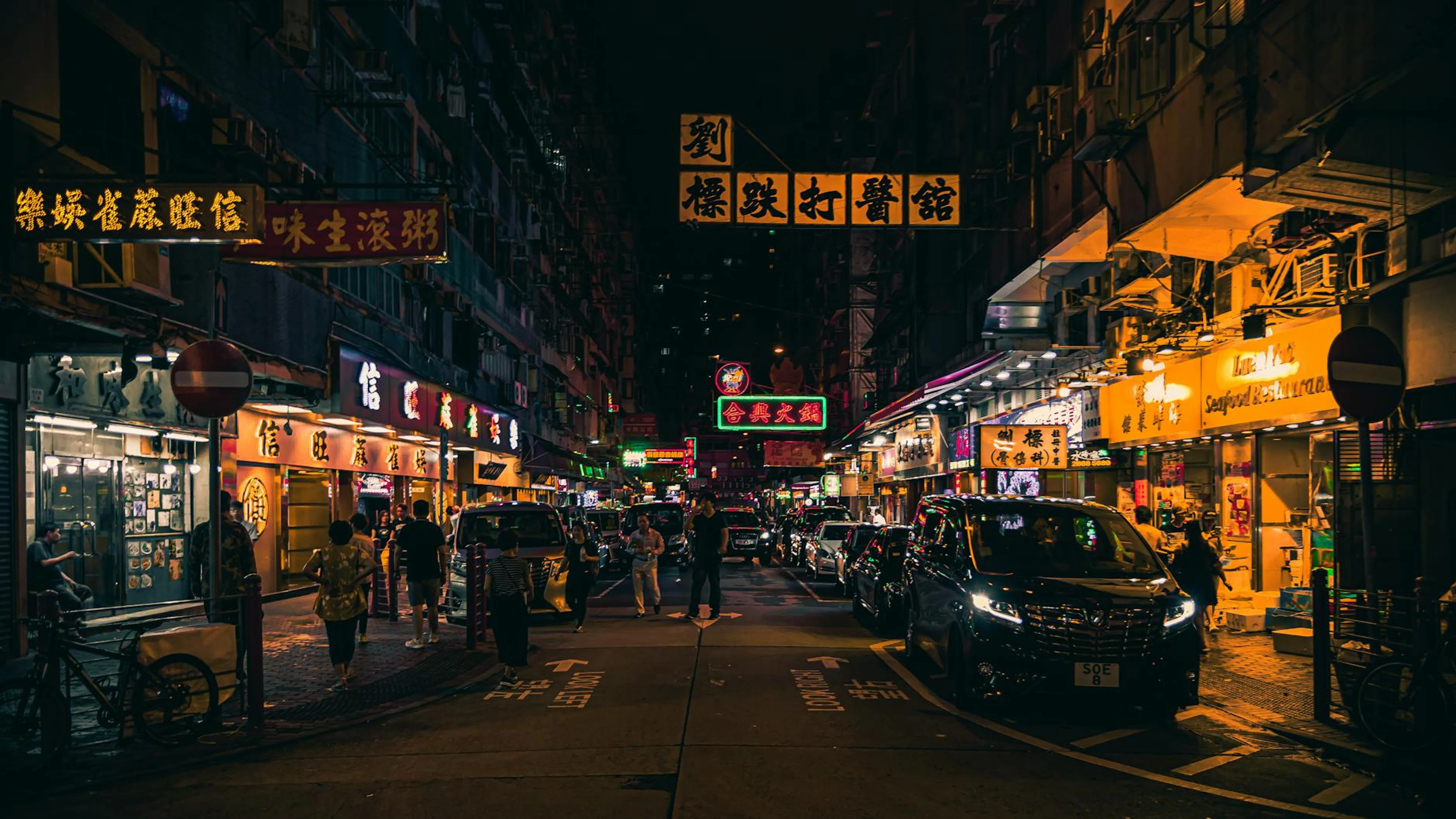 Explore the vibrant neon-lit streets of Hong Kong at night, bustling with energy - free 4K Ultra HD neon wallpaper for desktop