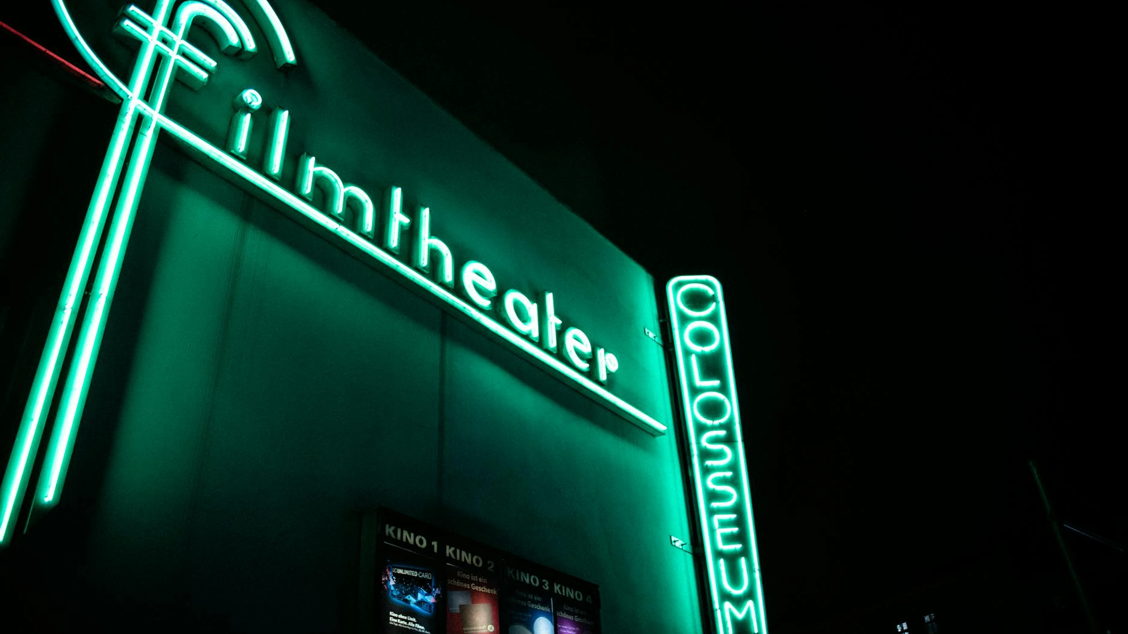 Vibrant neon film theater sign glowing at nighttime. - free 4K Ultra HD neon wallpaper for desktop
