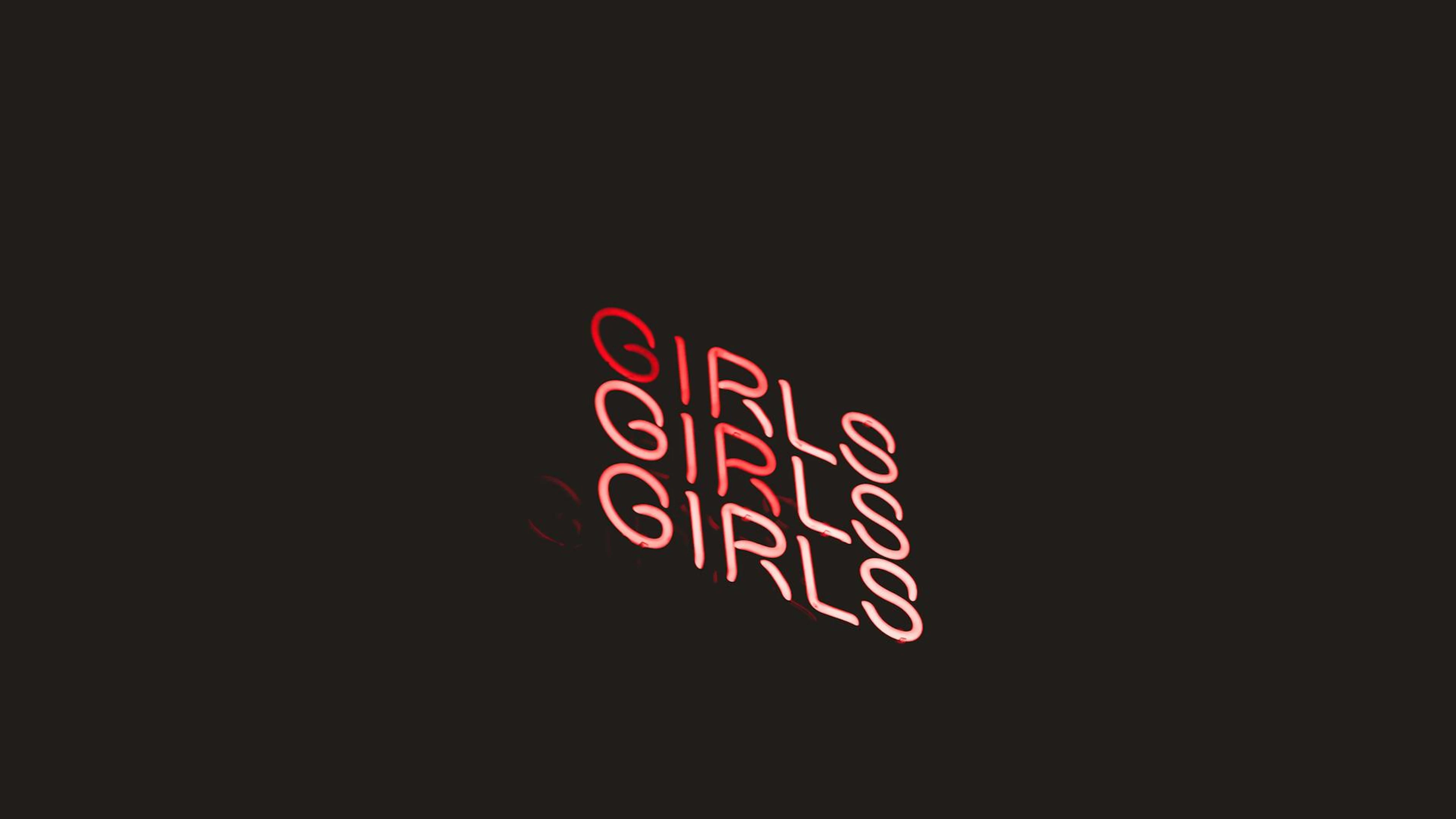 Vibrant neon sign displaying the word 'Girls' in red against a dark background. - free 4K Ultra HD neon wallpaper for desktop