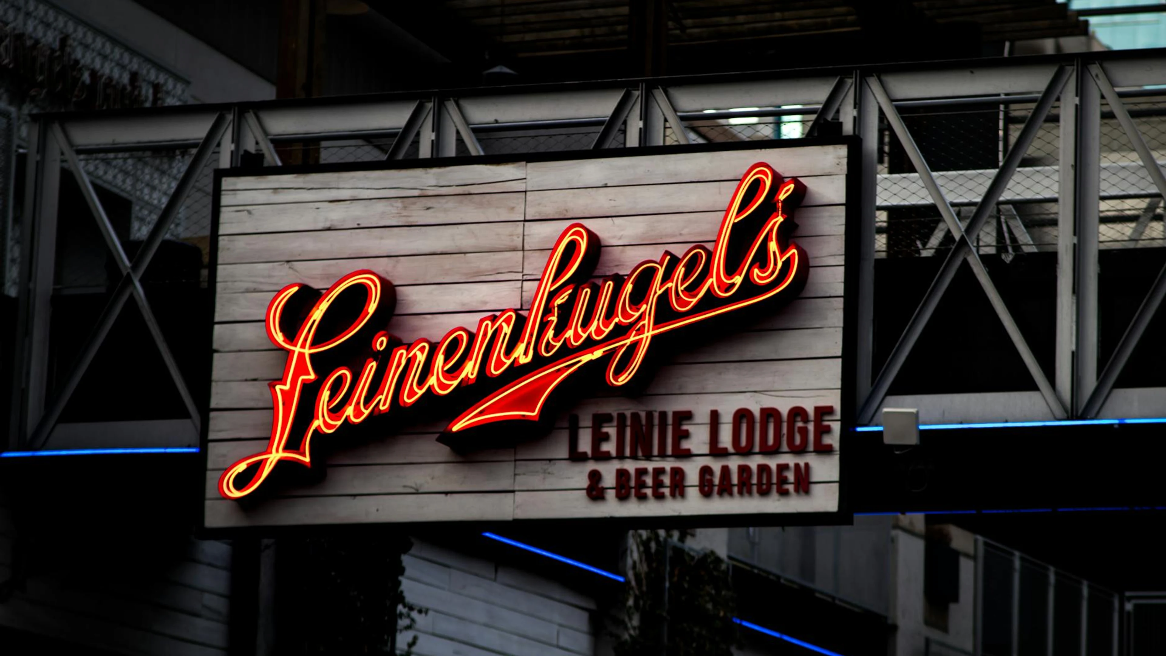 Vibrant neon sign promoting a beer garden, captured at night with warm lighting - free 4K Ultra HD neon wallpaper for desktop