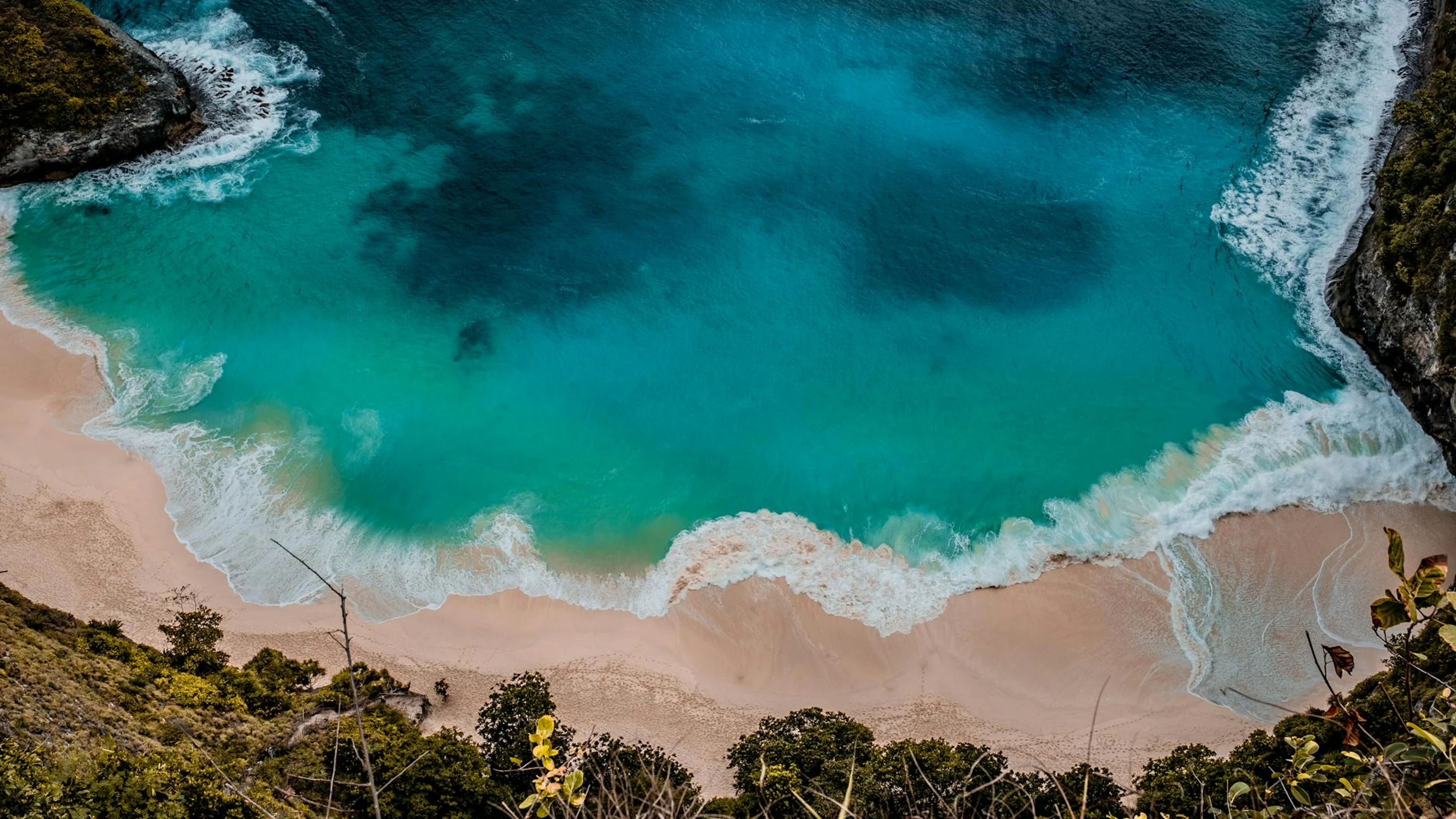 A breathtaking aerial shot capturing a turquoise beach with vibrant waves in Bal - free 4K Ultra HD ocean wallpaper for desktop