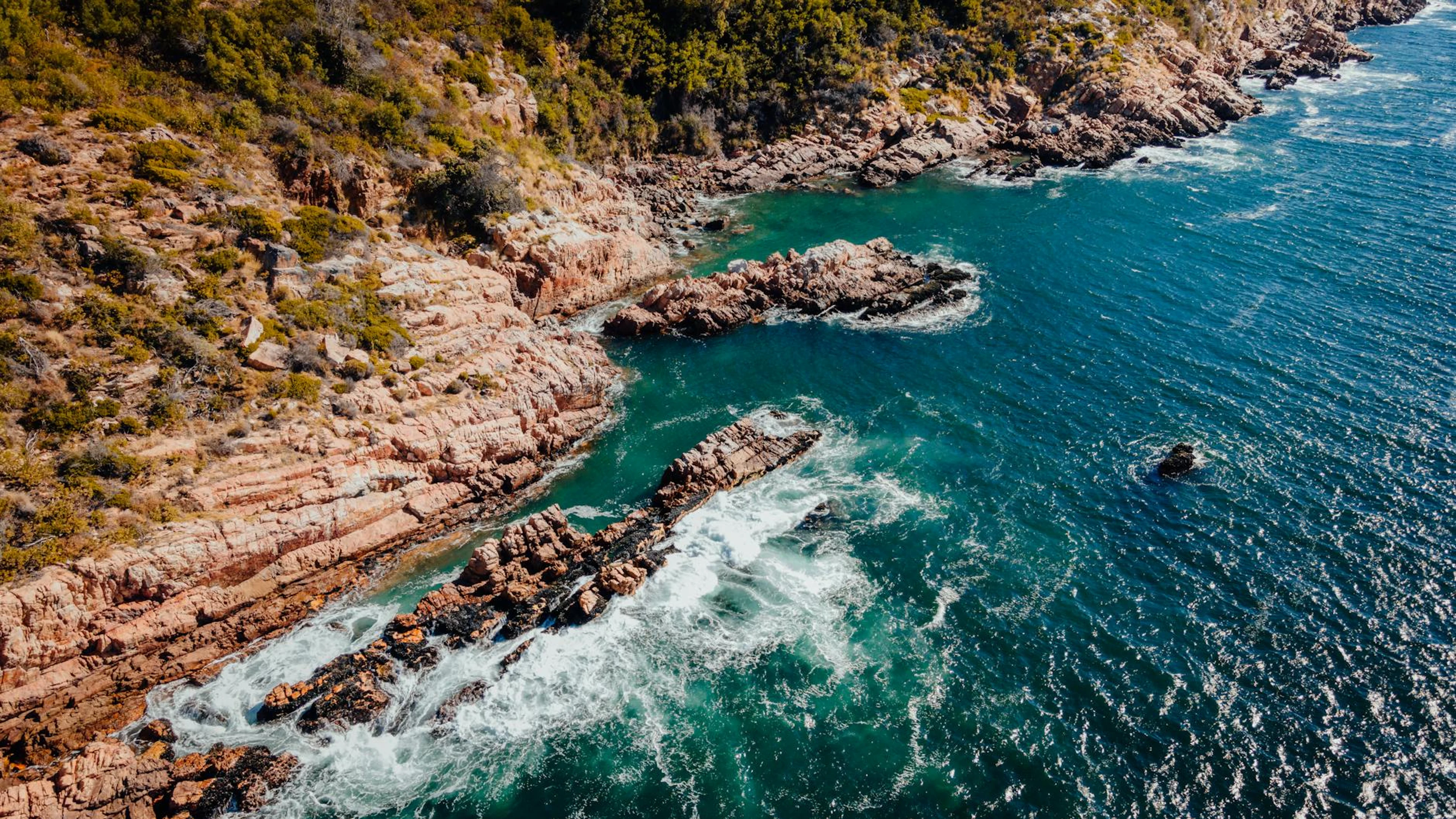 Breathtaking aerial shot of Cape Town's rugged coastal cliffs meeting the vibran - free 4K Ultra HD ocean wallpaper for desktop