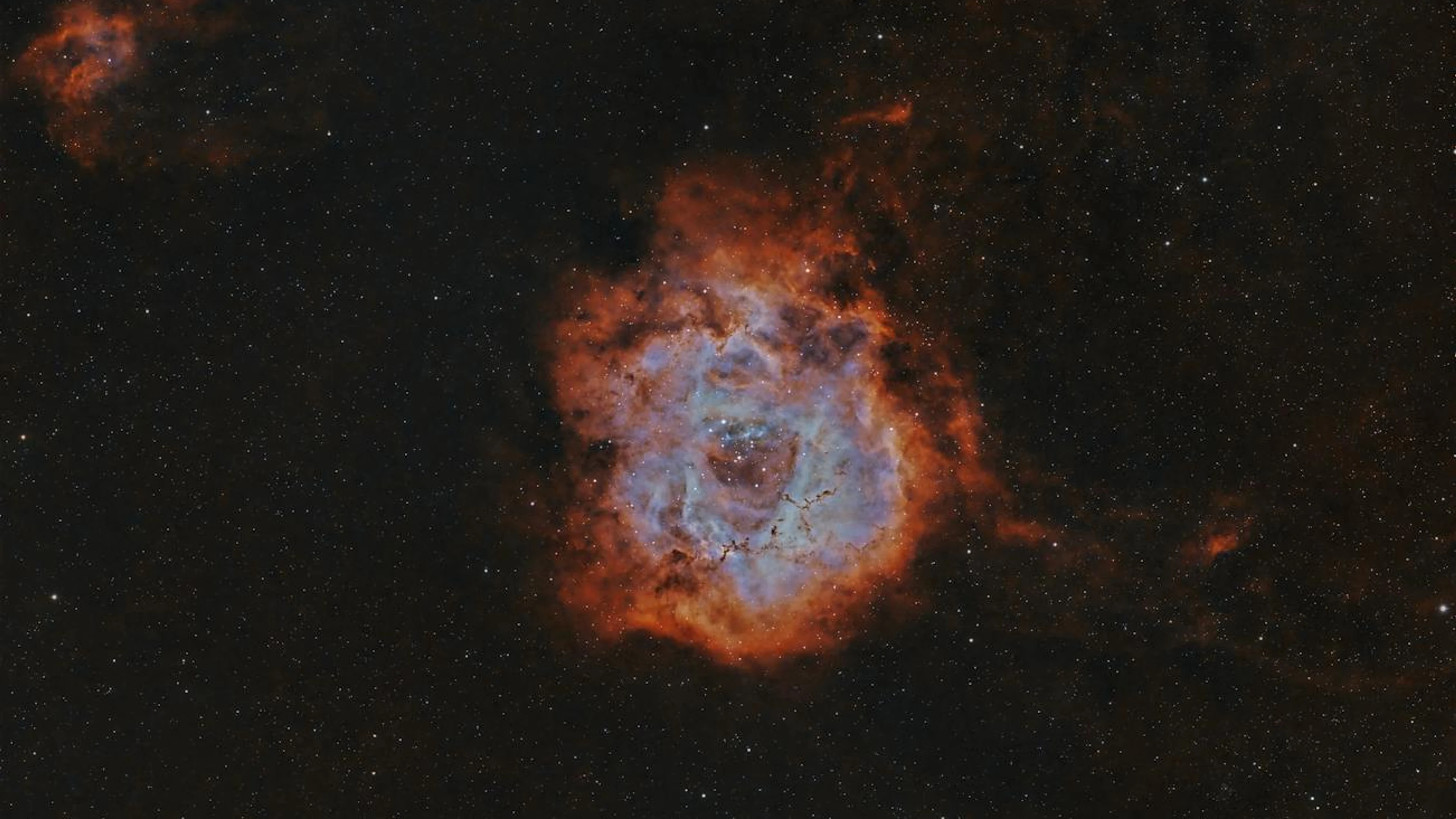 A breathtaking view of a glowing nebula surrounded by stars in deep space. - free 4K Ultra HD space wallpaper for desktop