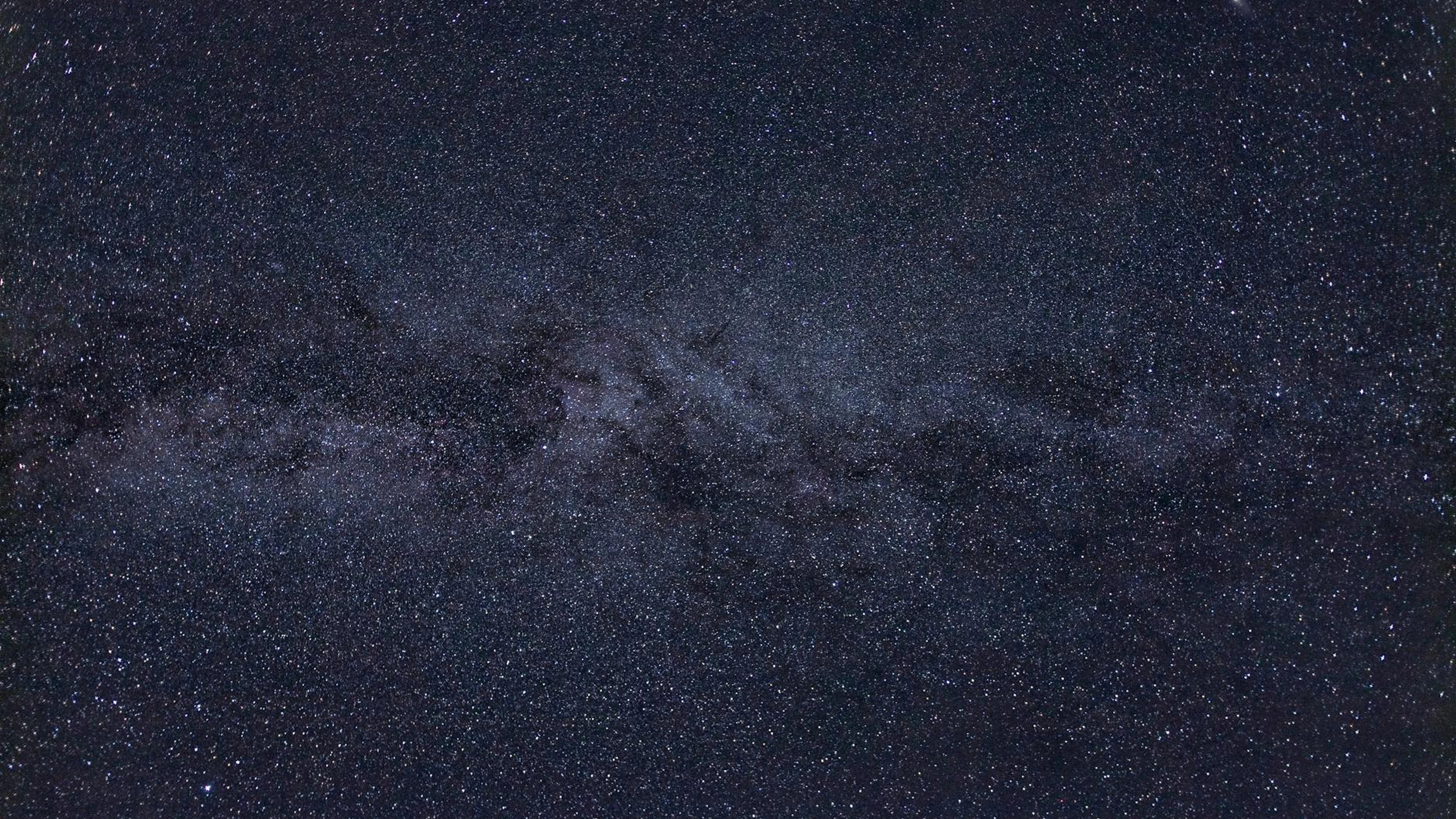 A breathtaking view of a starry night sky showcasing the Milky Way and countless - free 4K Ultra HD space wallpaper for desktop