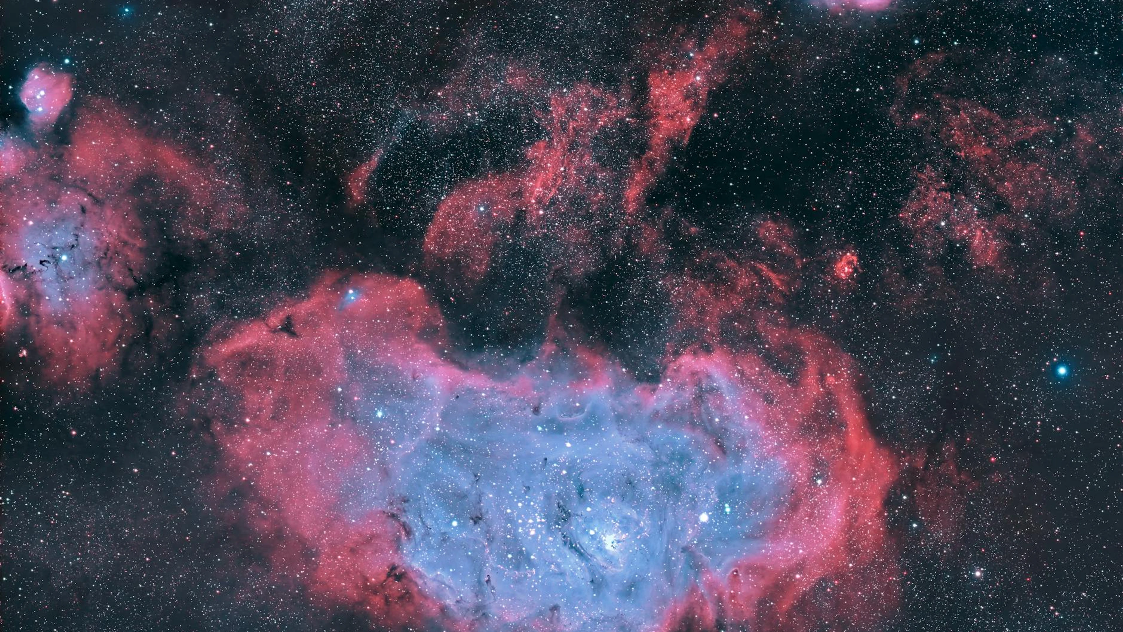 Breathtaking view of a vibrant nebula, showcasing cosmic colors and stars in dee - free 4K Ultra HD space wallpaper for desktop