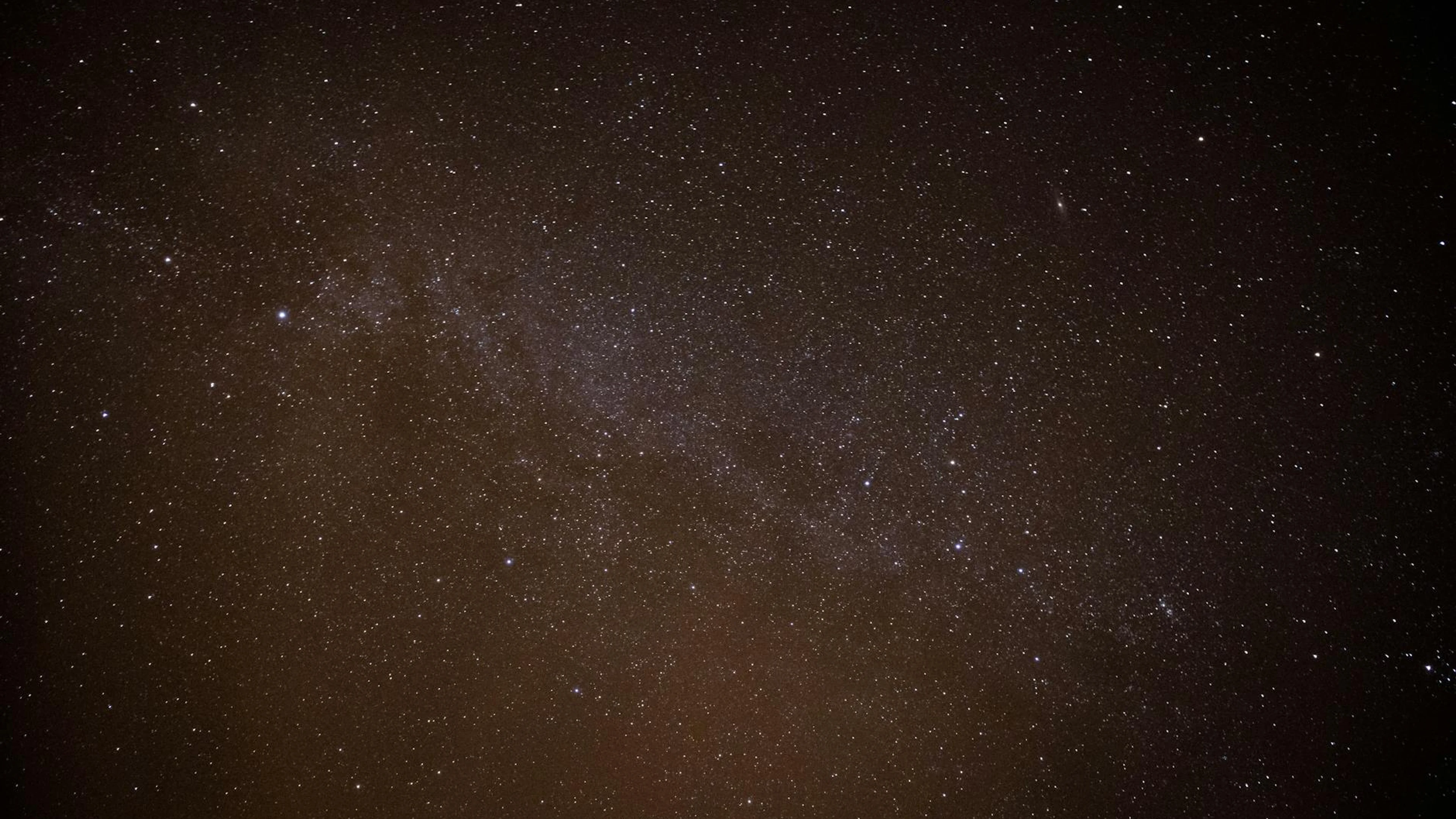 Explore the vastness of the starry night sky featuring the Milky Way galaxy's br - free 4K Ultra HD space wallpaper for desktop