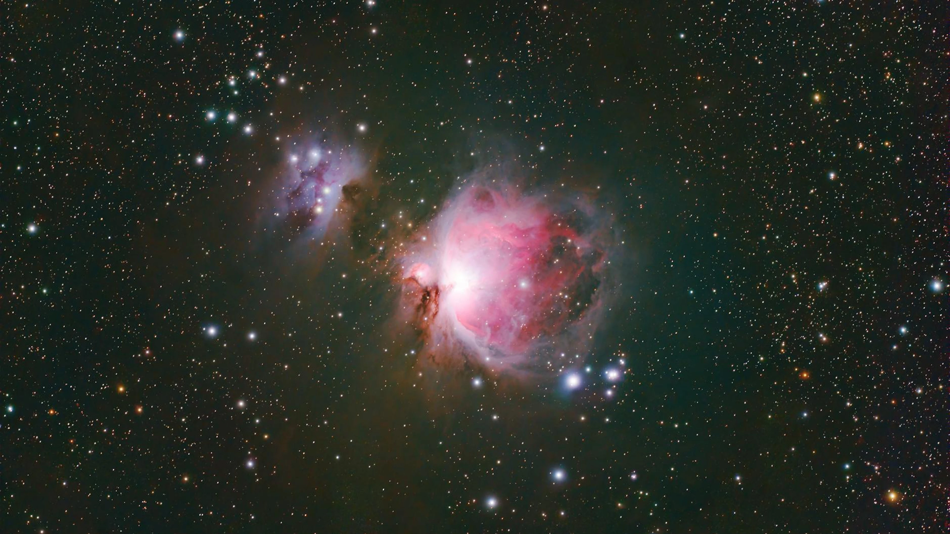 Stunning capture of the Orion Nebula (M42) showcasing vibrant colors and cosmic - free 4K Ultra HD space wallpaper for desktop