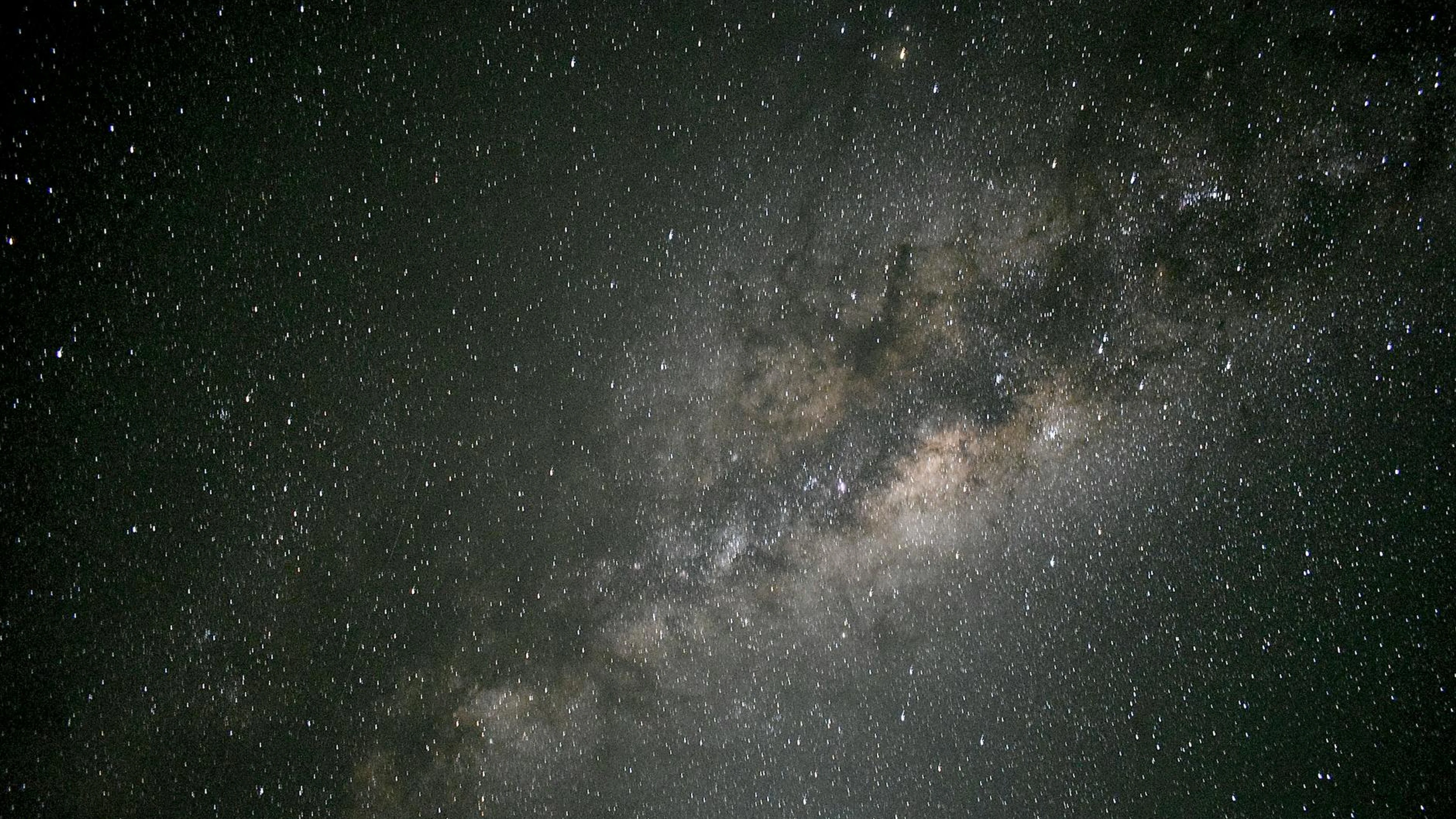 Stunning photograph of the Milky Way galaxy shining brightly in the night sky. - free 4K Ultra HD space wallpaper for desktop