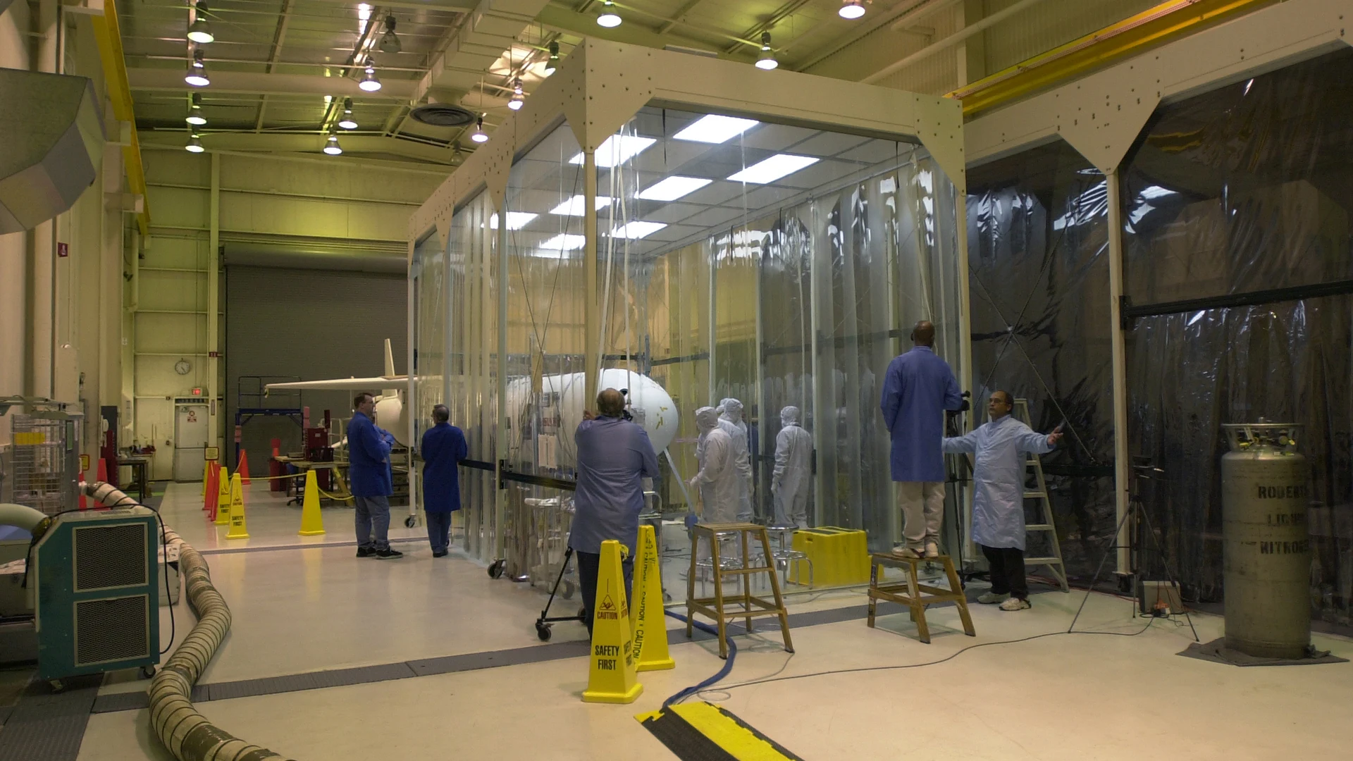Technicians prepare the AIM spacecraft for fairing installation - free hd space wallpaper for desktop